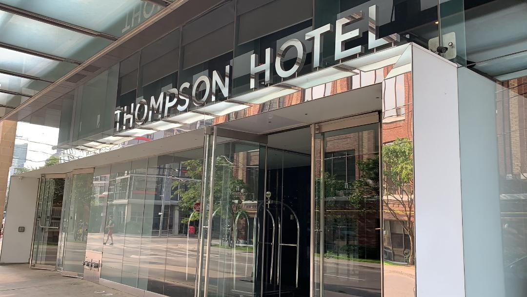 Entrance of the Thompson Hotel Toronto with silver letters.