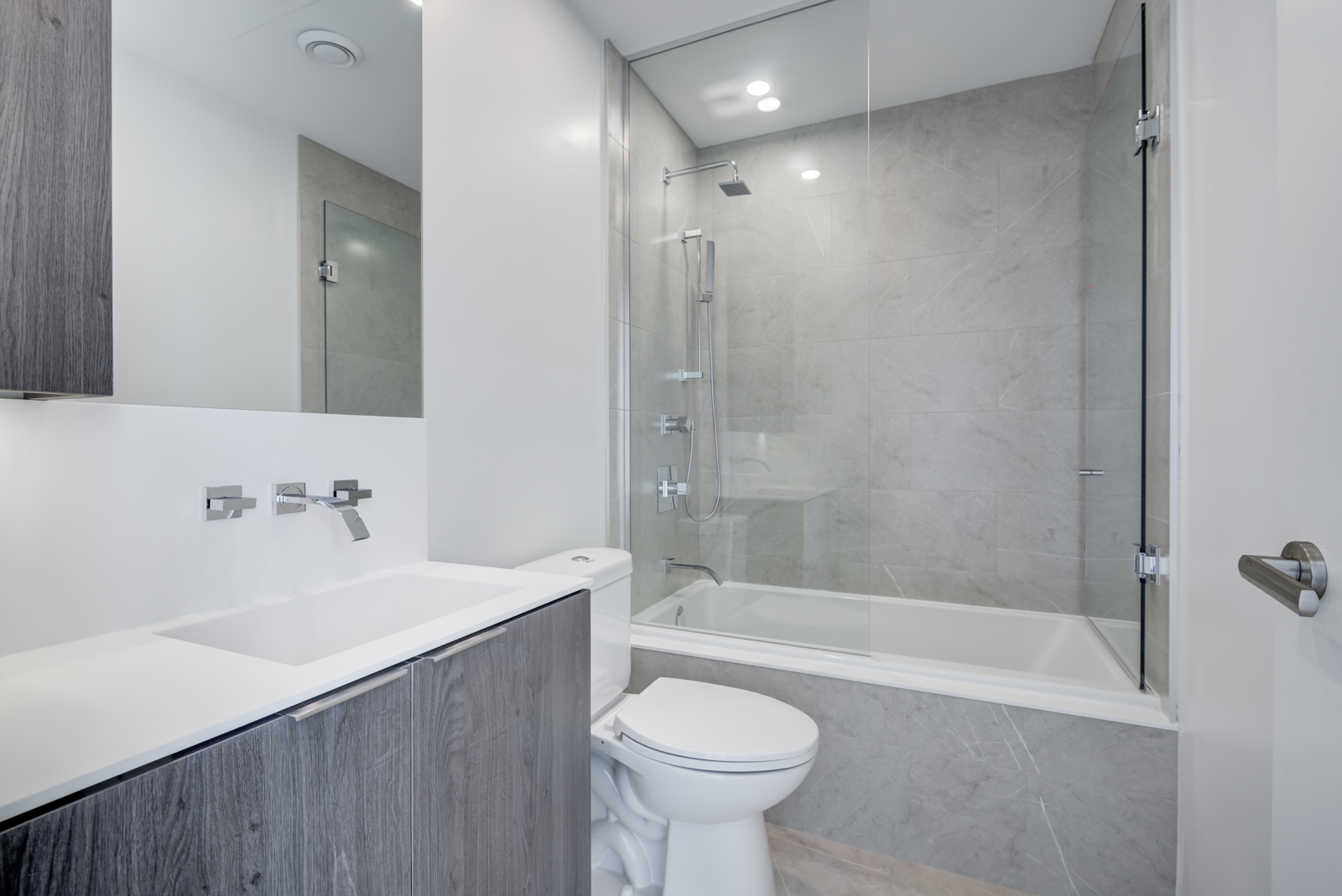 Photo of bathroom and sink, faucet, tub and shower.