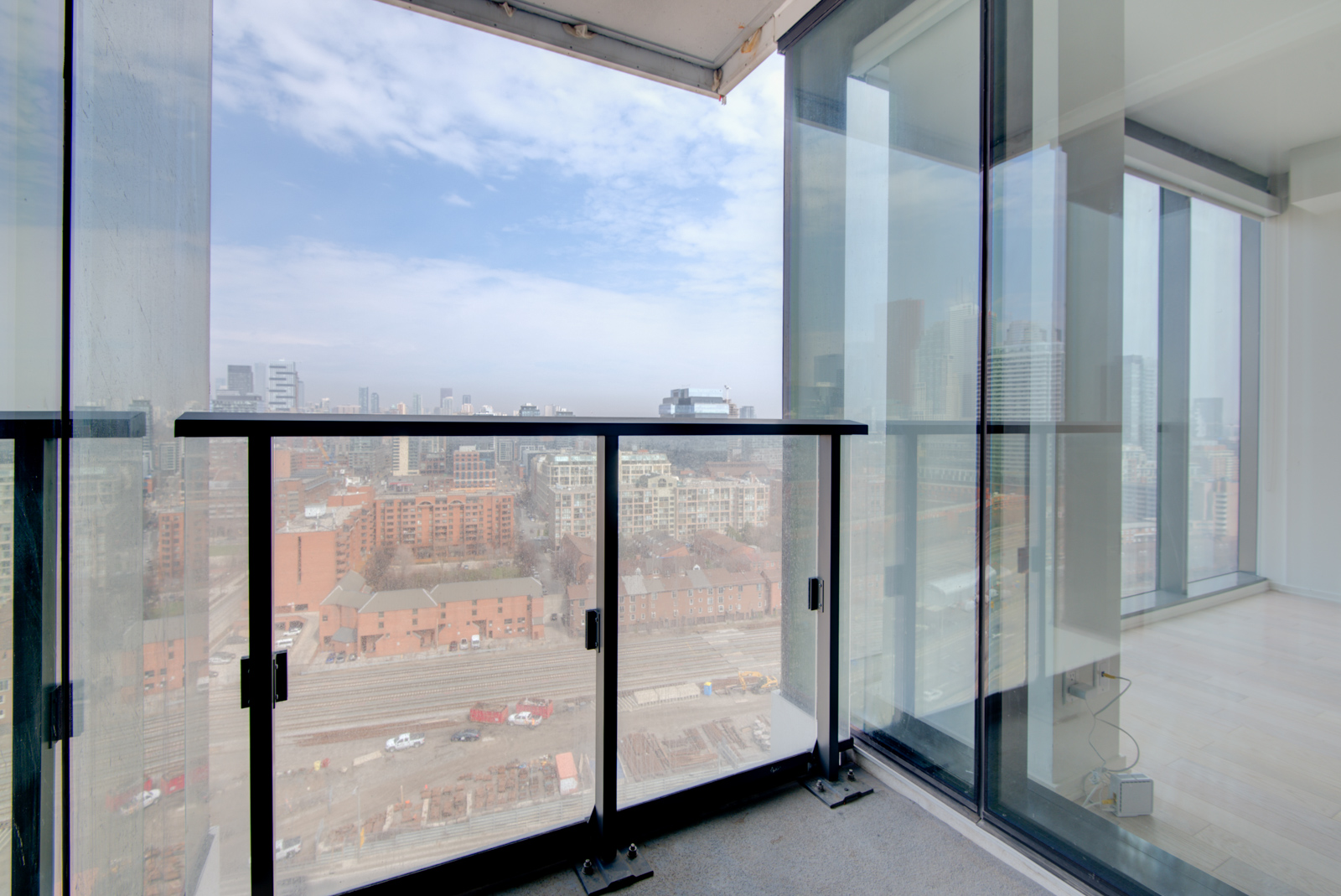 Image of Unit 1703 balcony and buildings below.