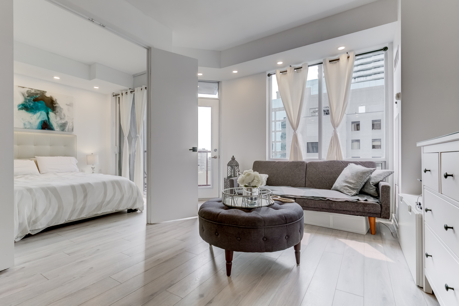 Open-concept design of 85 Bloor Unit 1814 with living room and open bedroom doors.