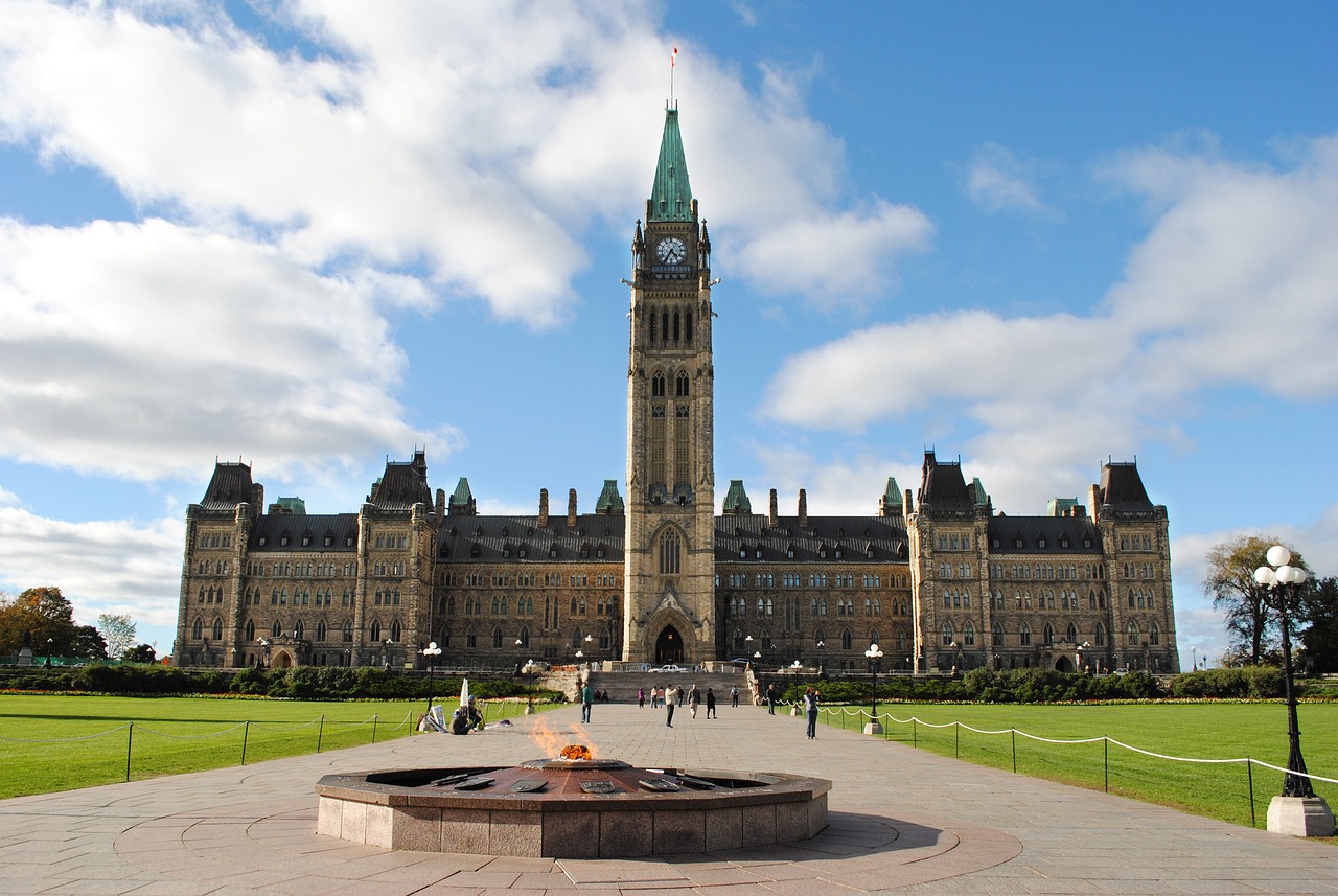 Centennial Flame in foreground; Ottawa Parliament building in background.