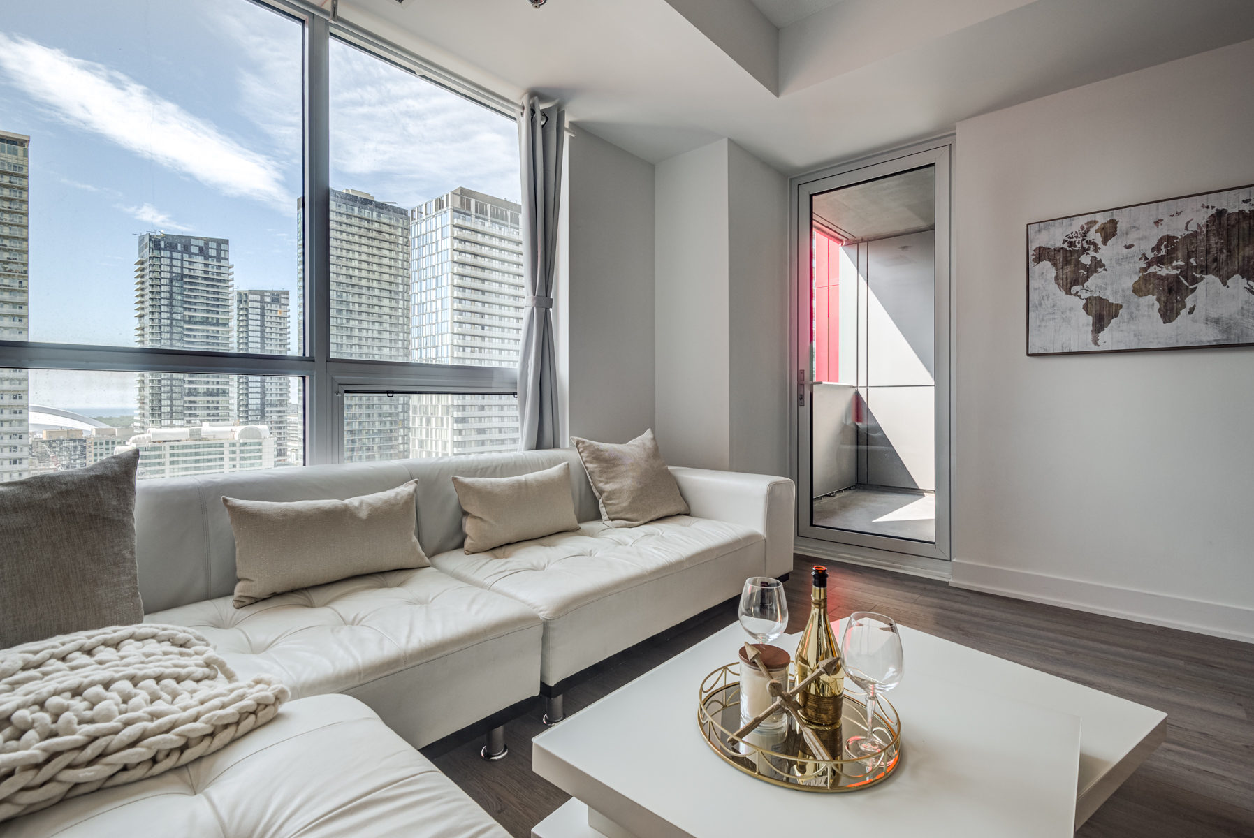 Condo living room with gray walls, furniture and painting.