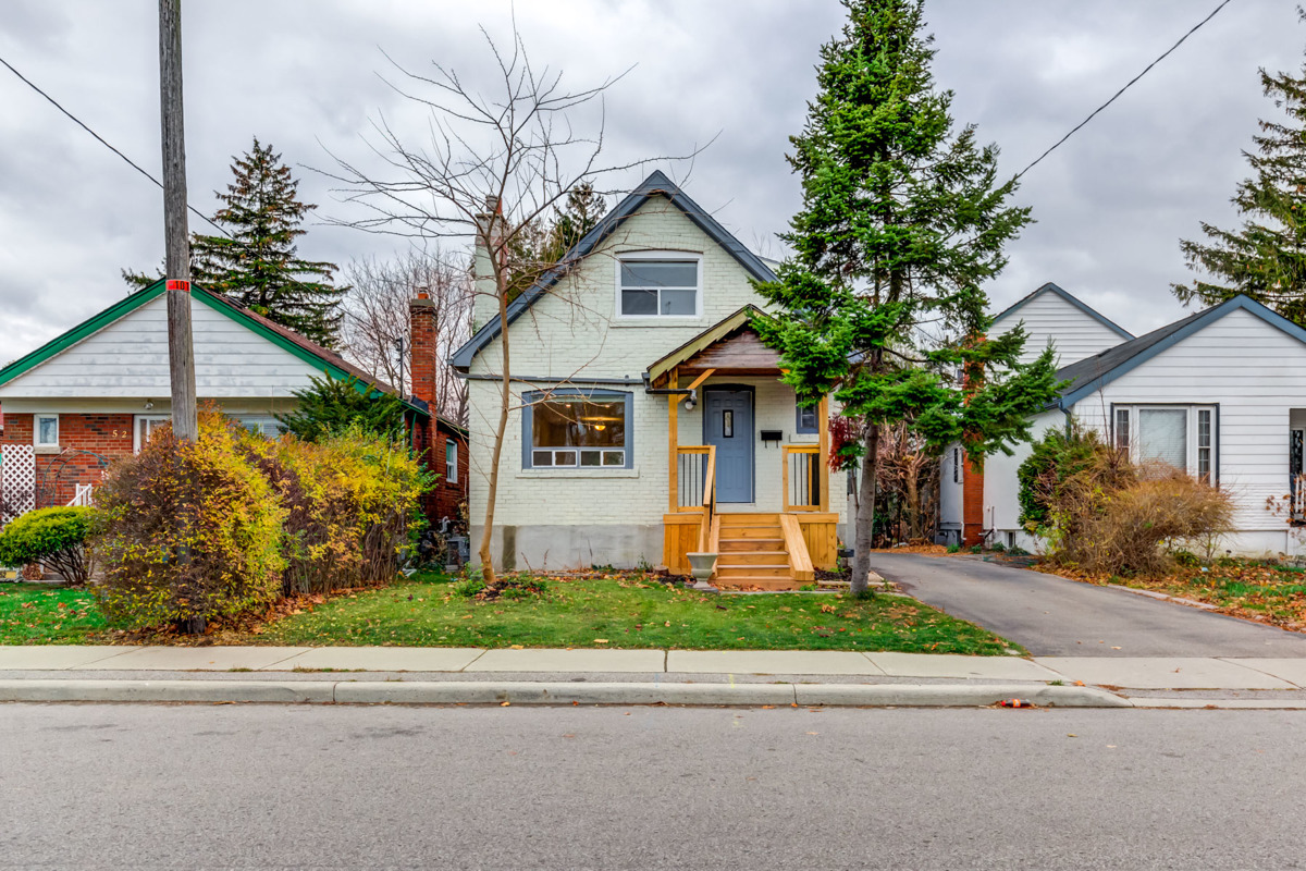 Front view of 54 Huntington Ave, front yard and trees.