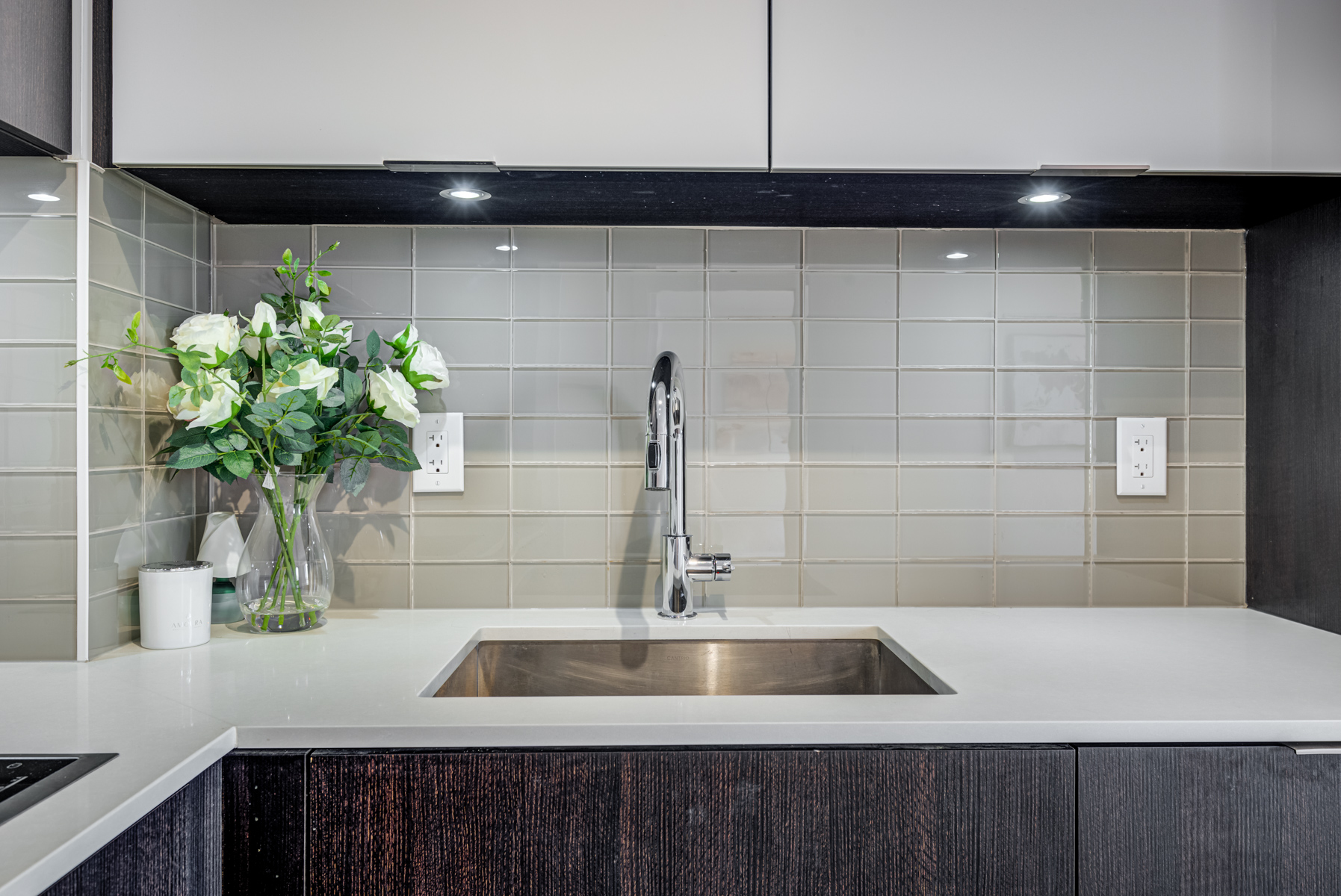 Close up of condo kitchen towels, cabinets and back-splash.