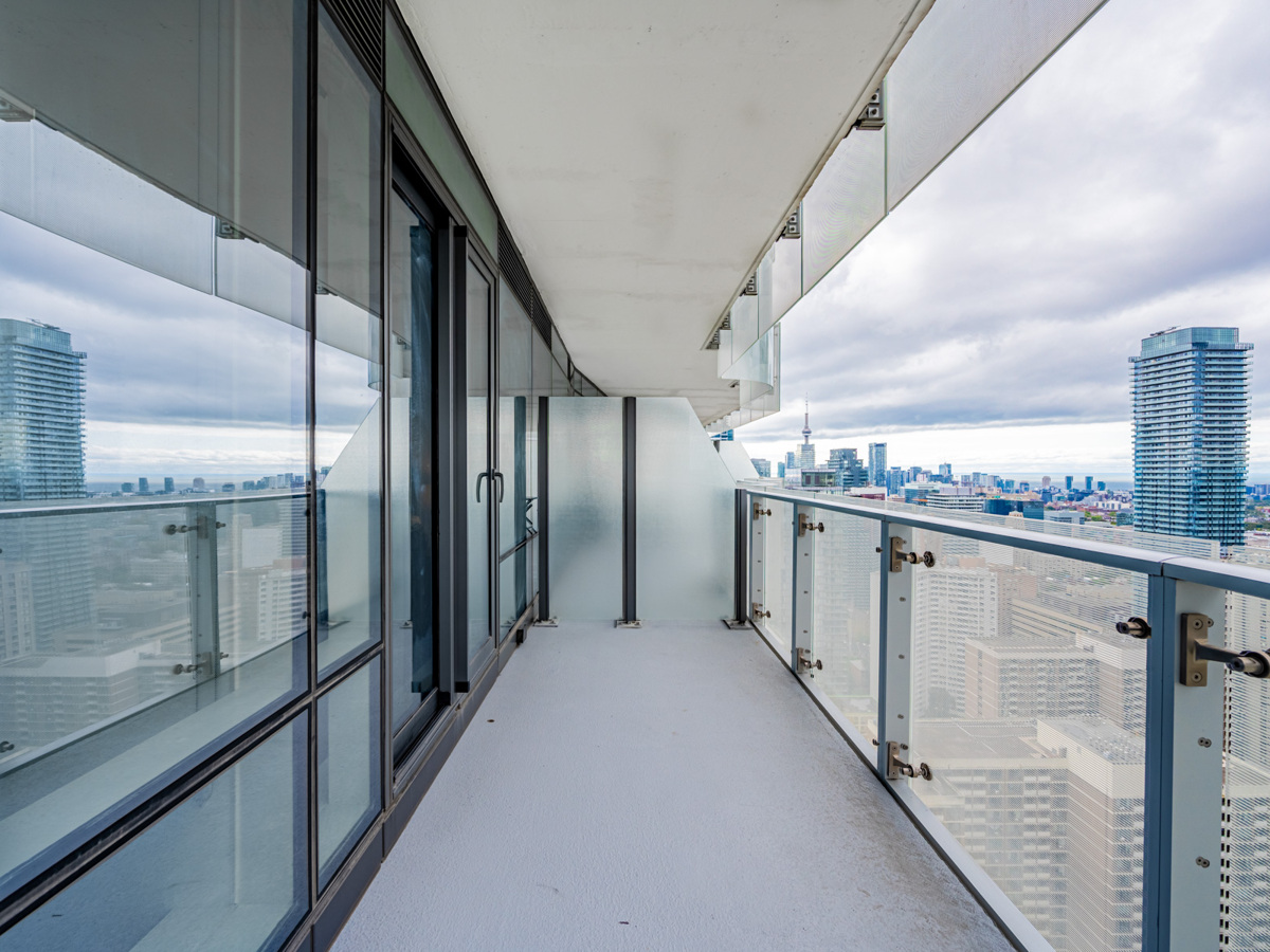 1 Bloor St E Unit 3409 balcony with glazed dividers and semi-transparent glass.