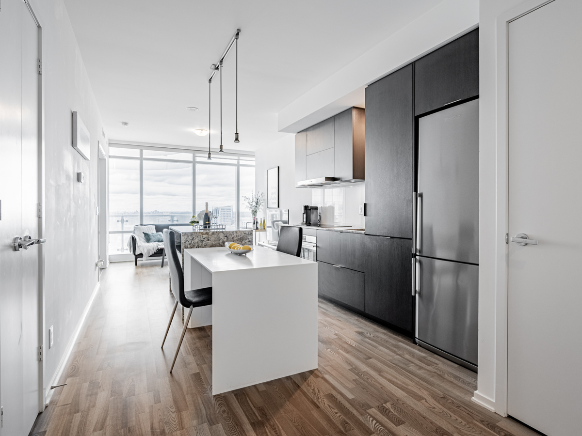 1 Bloor St E Unit 3409 kitchen dining table and island.