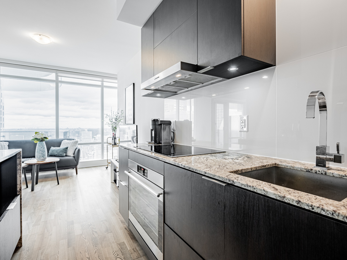 Modern condo kitchen with granite counters.