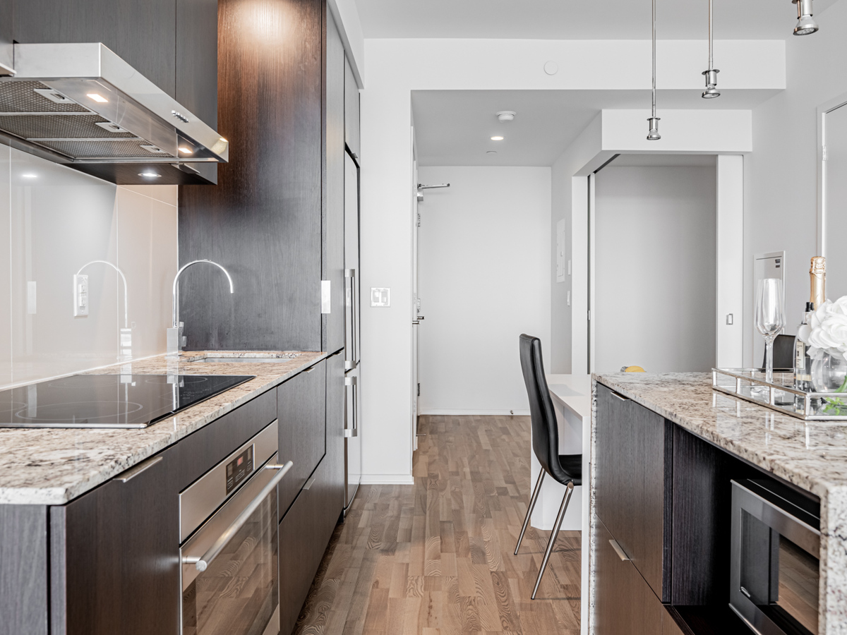 Potlights, pendant lamps and under-cabinet lights – 1 Bloor St E Unit 3409 kitchen.