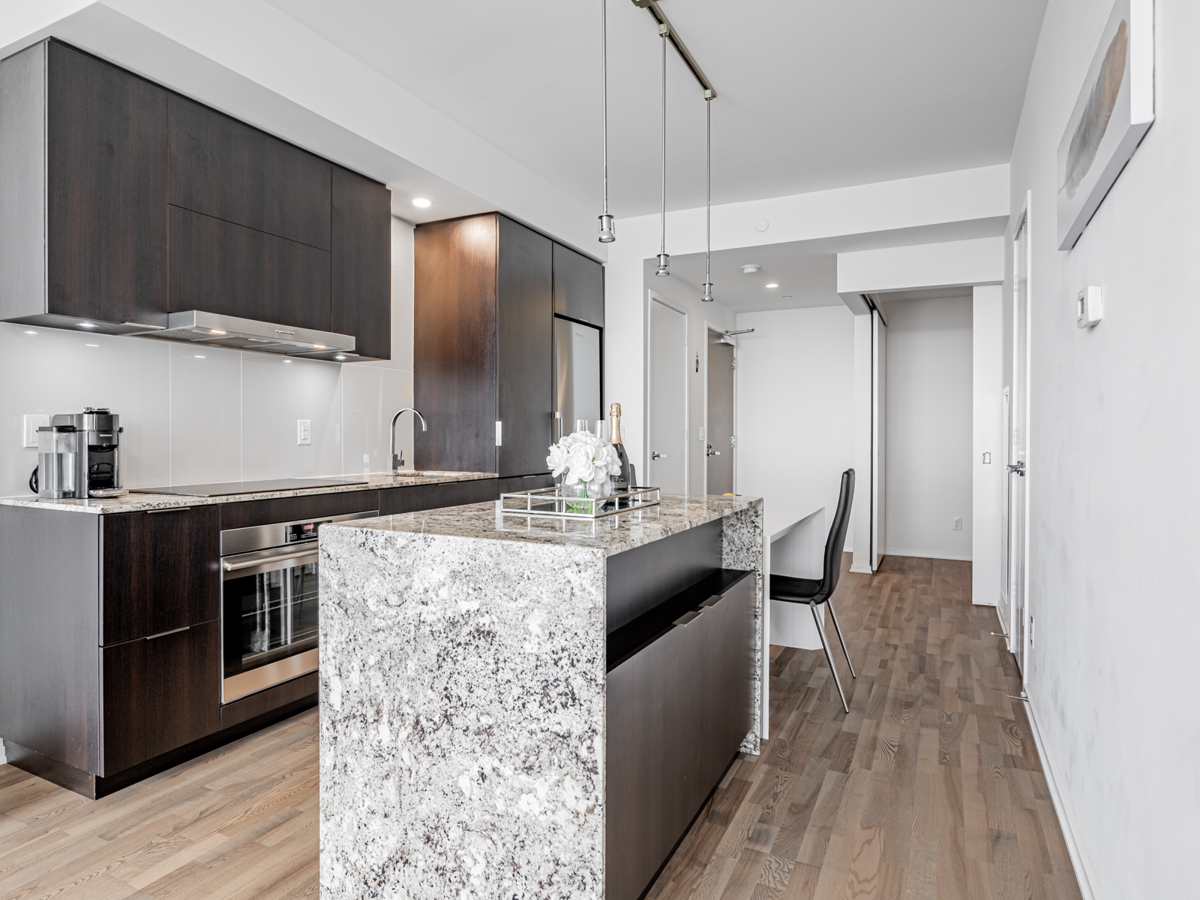 Condo kitchen with granite island.