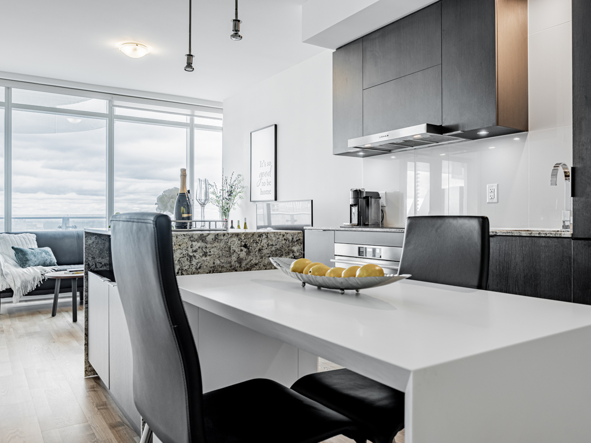 Condo kitchen with white dining table.