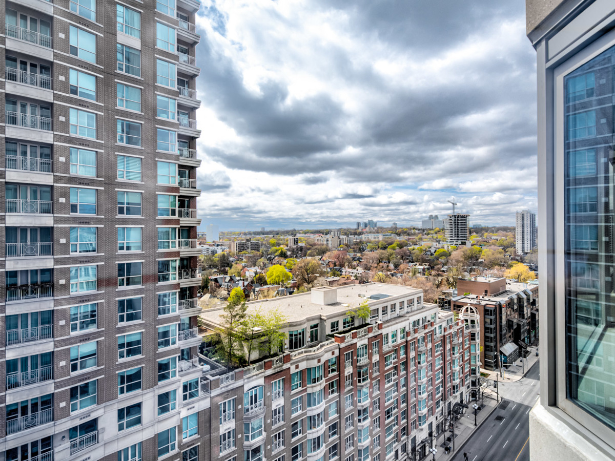 View of buildings, streets and trees in Yorkville, Toronto from 16th floor balcony.