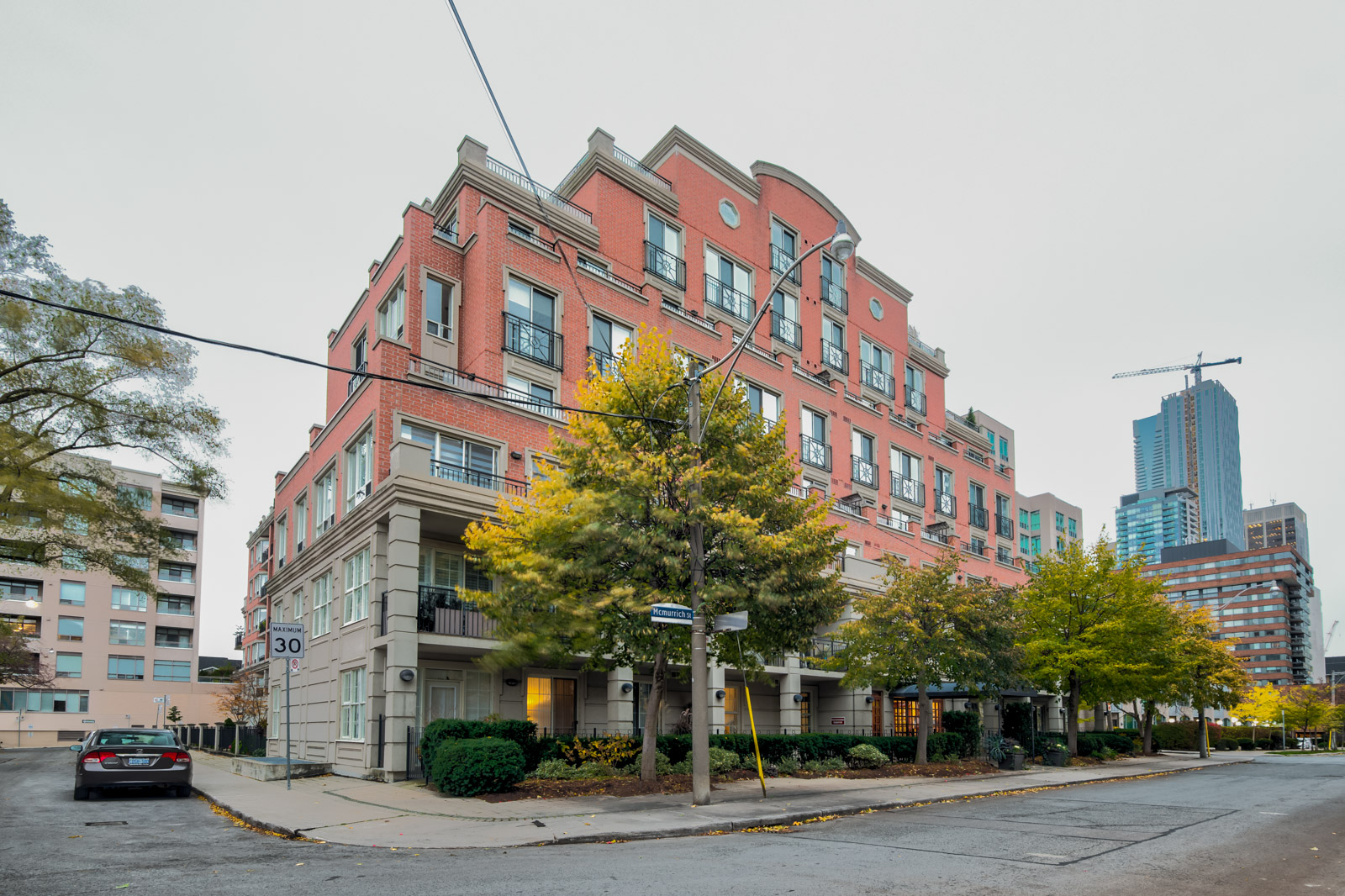 Red-brick exterior of McMurrich Residences in Yorkville, Toronto.