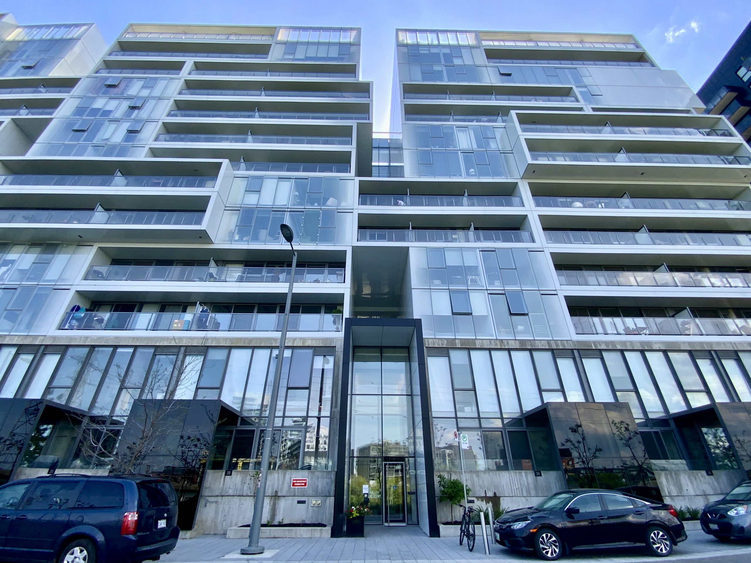 Looking up at River City 2 Condos blue glass, geometric exterior.