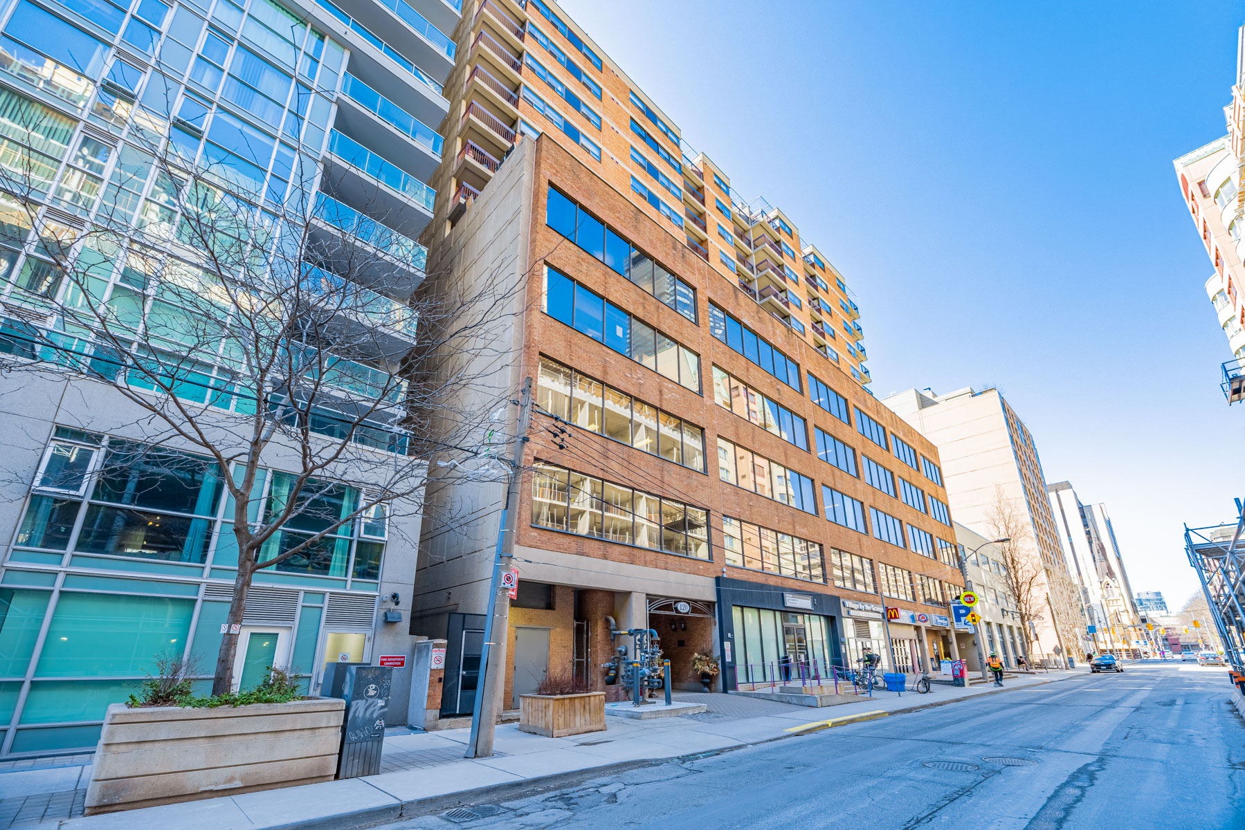 Red-brick facade of Village By The Grange mid-rise condo.