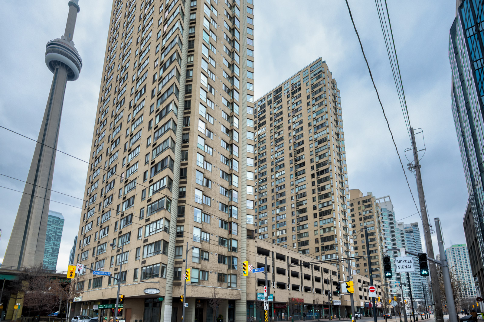 CN Tower in background with beige brick Harbourpoint II in foreground.