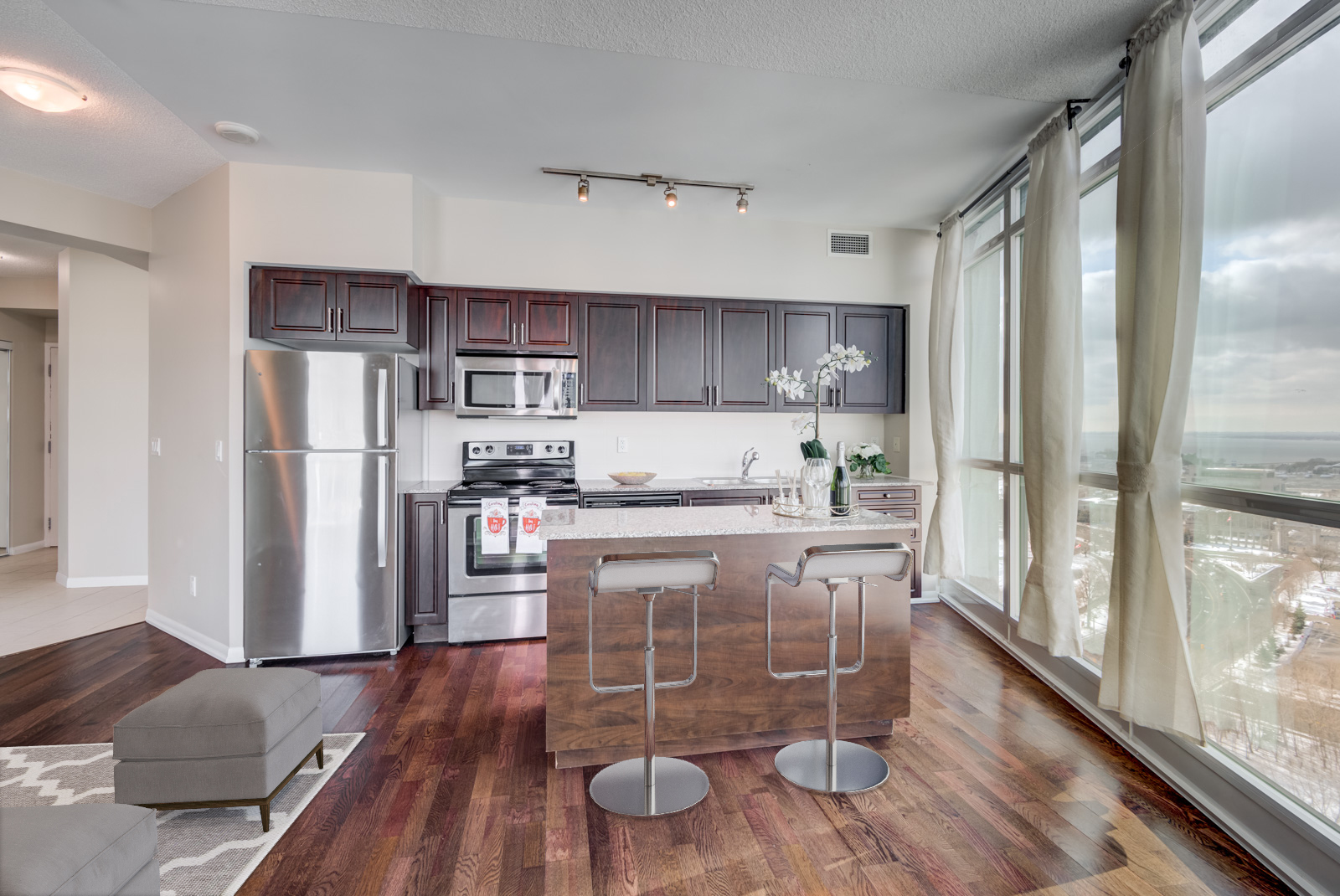 3D render of 215 Fort York Blvd kitchen island with two stools.