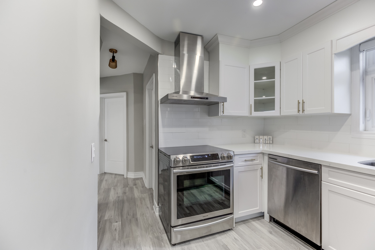 Brand new silver range hood, stove and dishwasher.