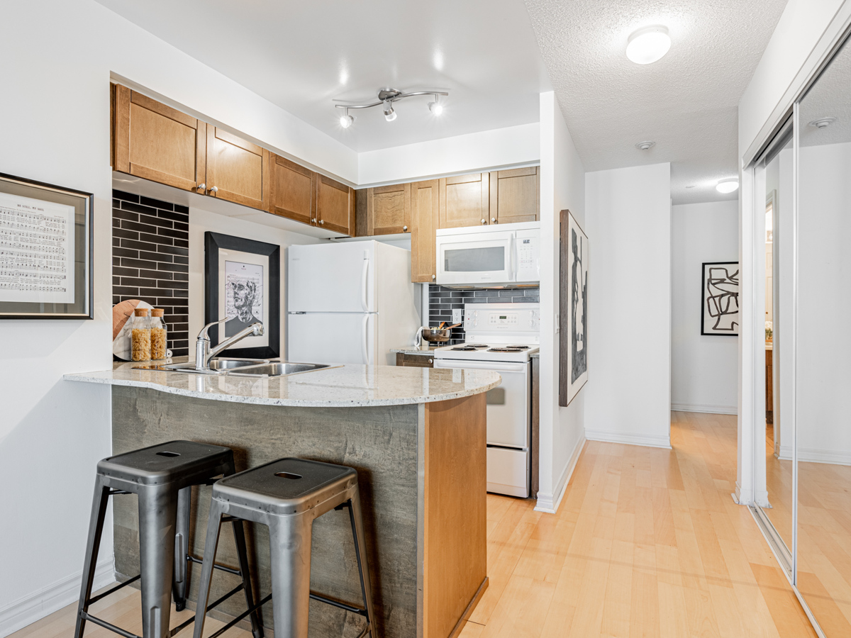 Condo kitchen with curving breakfast bar.