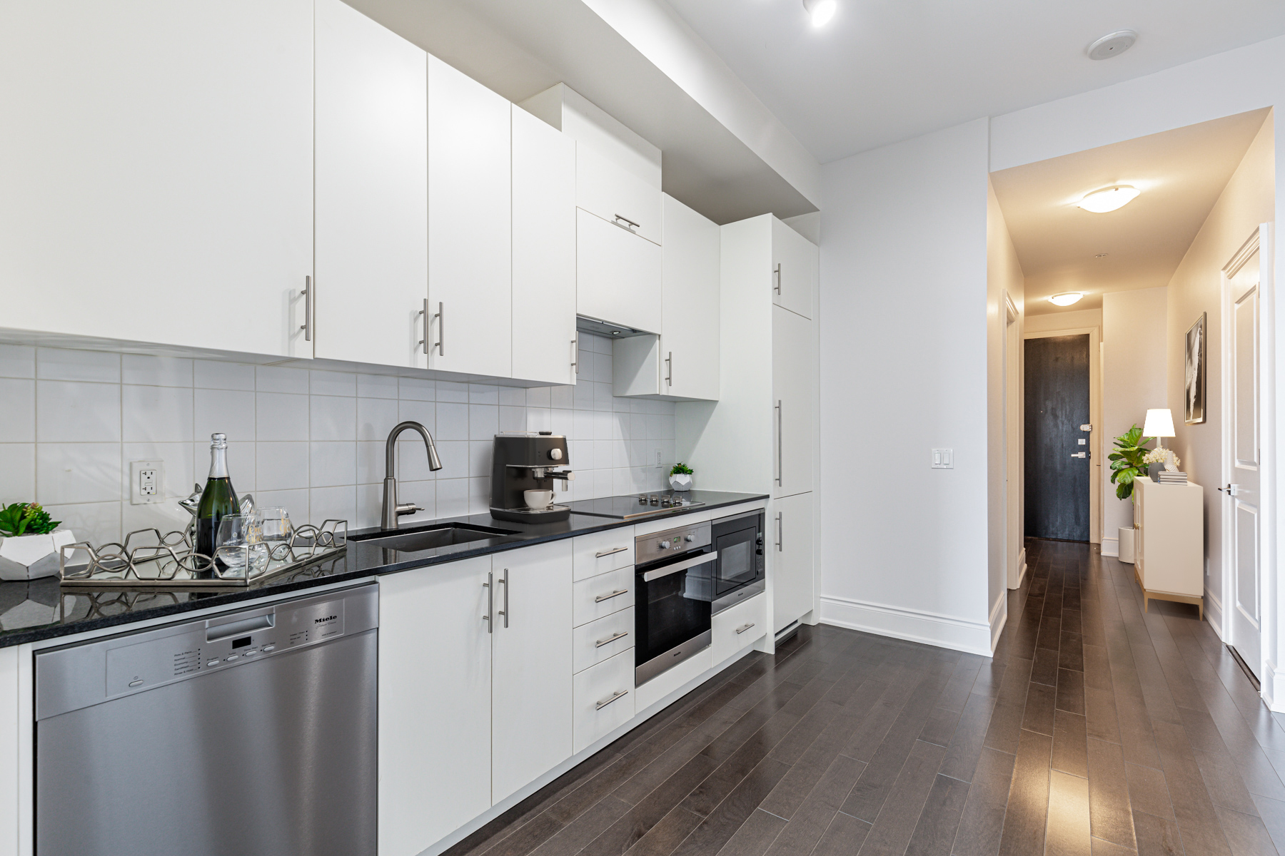 Condo kitchen stretching from wall to wall.