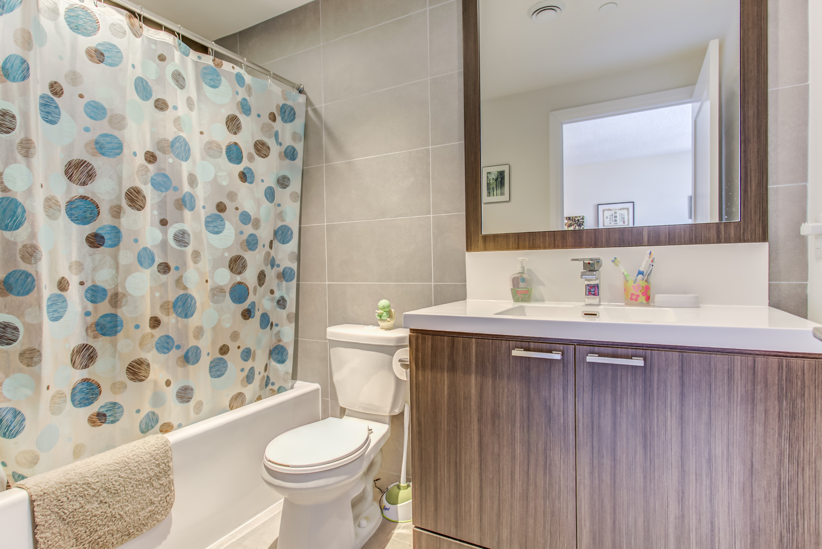 Bathroom photo with tub, sink, tiles and mirror.