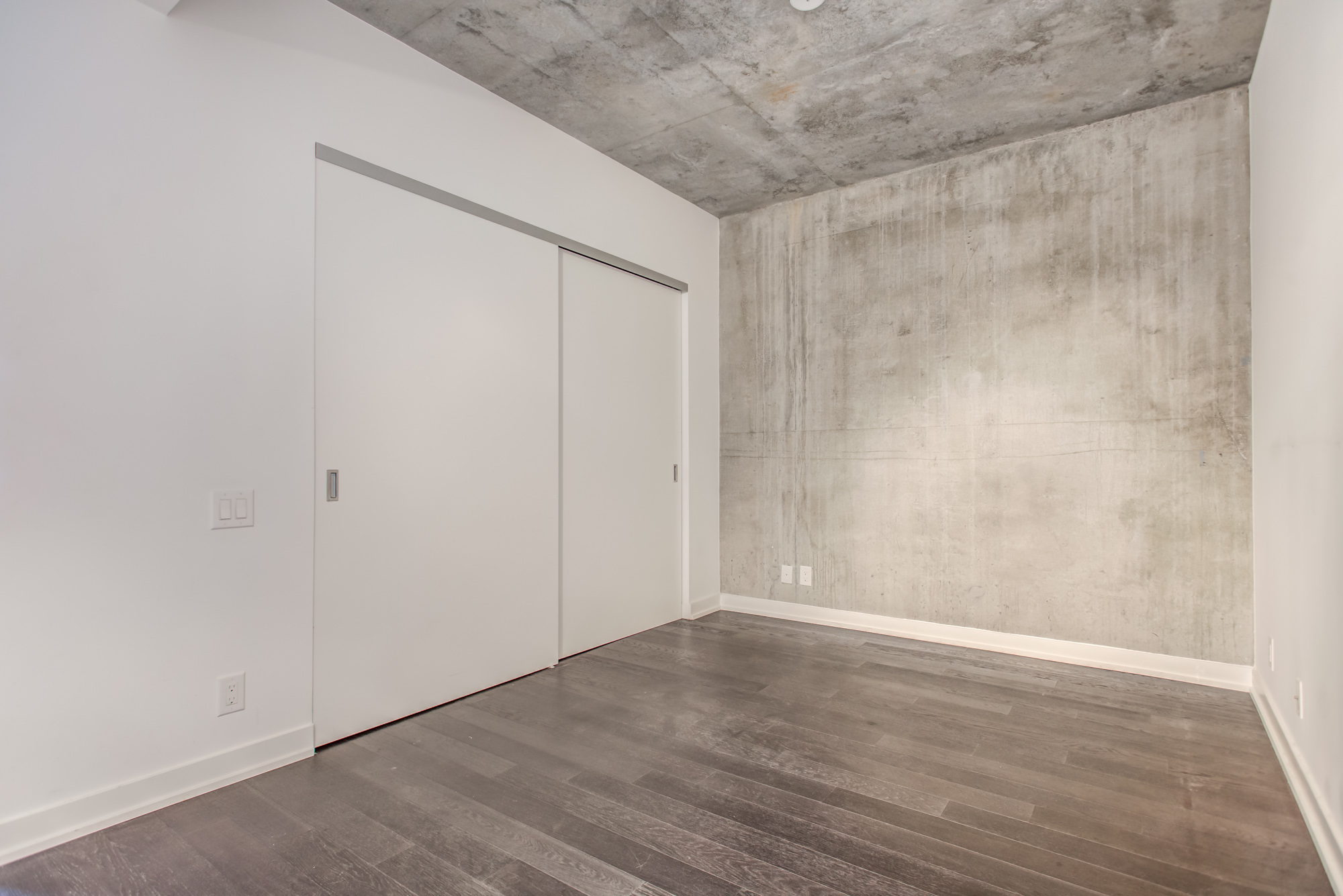 39 Brant St Unit 918, Brant Park Lofts, in Queen West, master bedroom with exposed ceiling and wall.