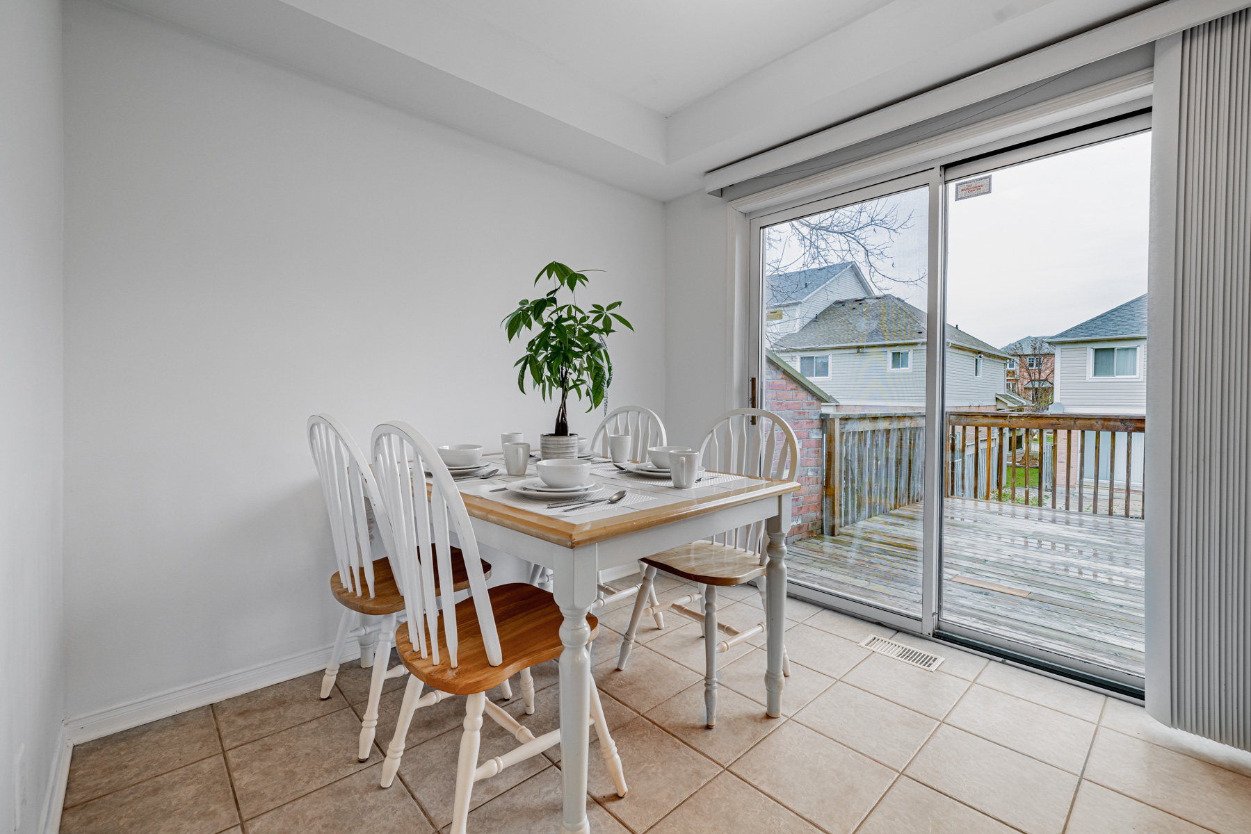 77 Schouten Cres breakfast book with dining table, chairs and view of backyard.