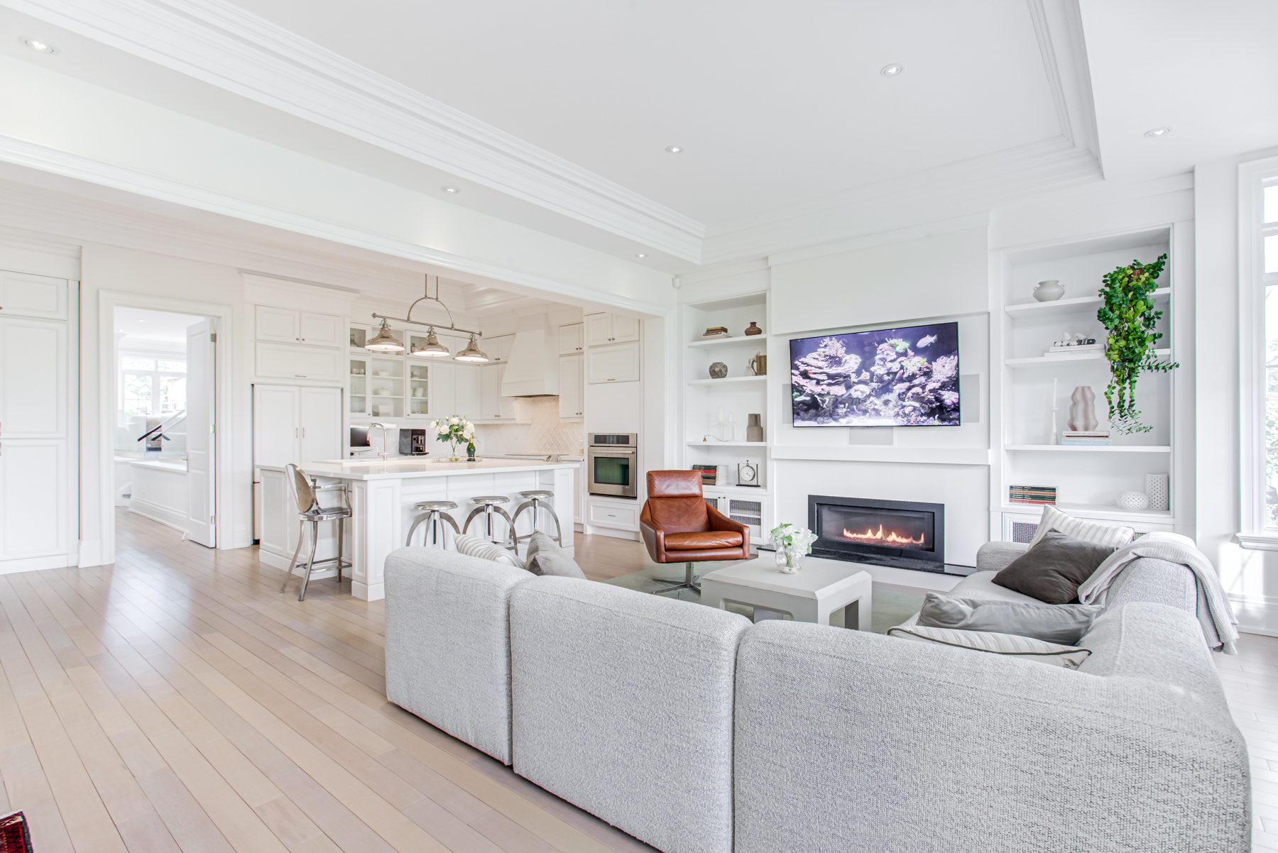 Opulent family room with gas fireplace, marble hearth and built-in bookshelves.