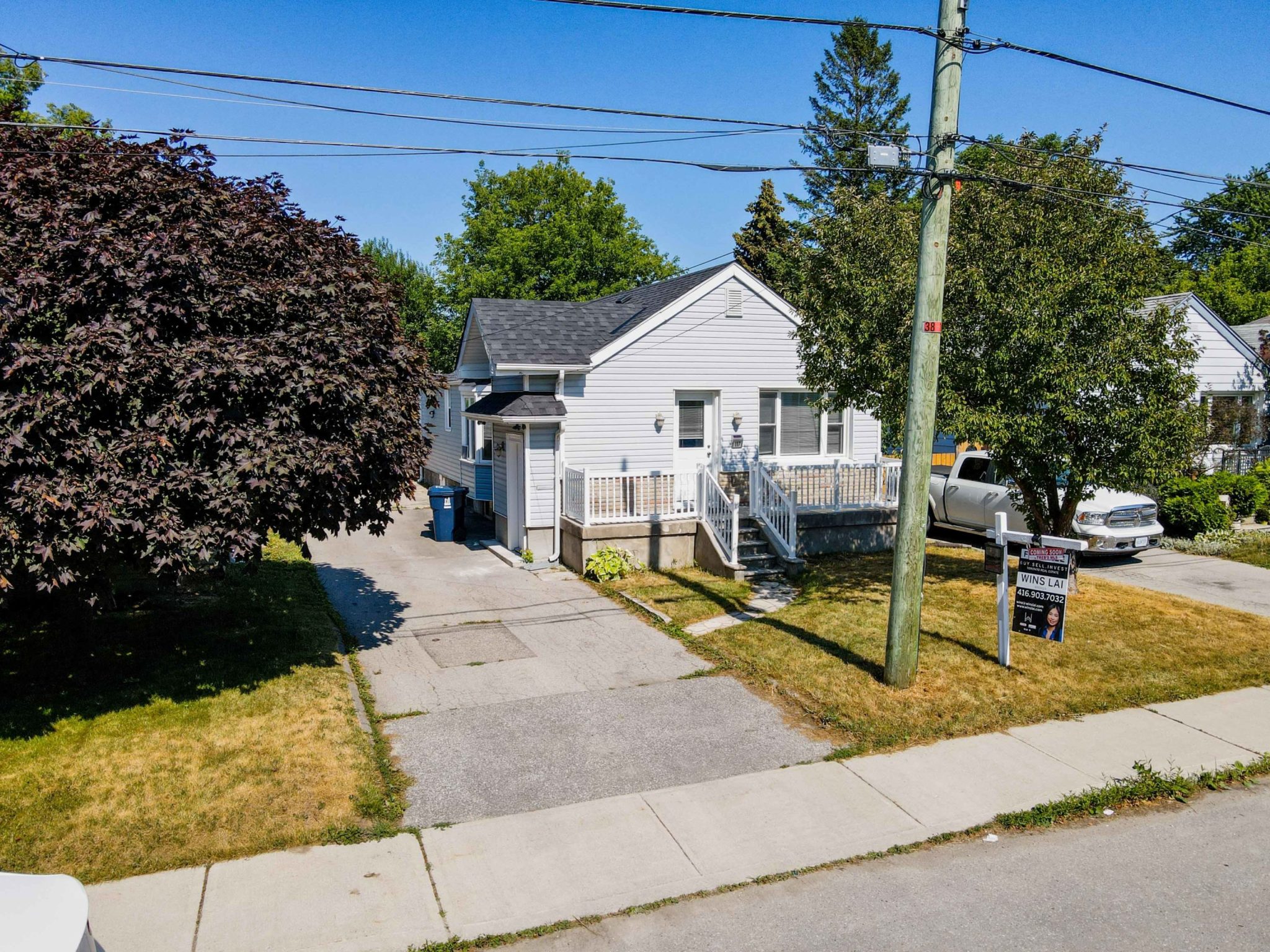 Front of house in suburbs with big driveway