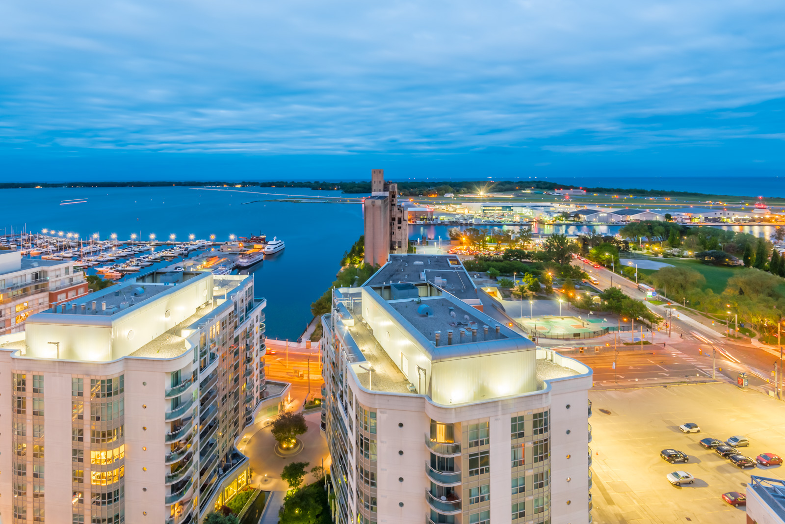 Condos and boats in Toronto's Waterfront at night.