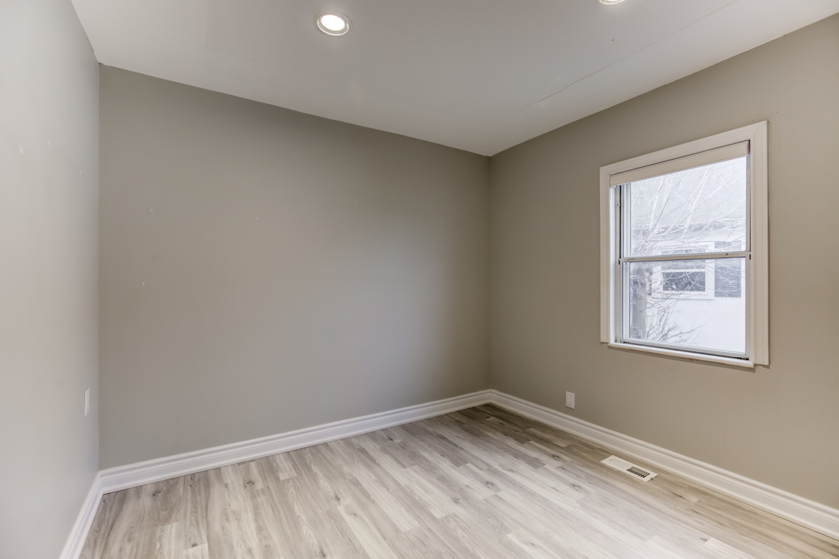 54 Huntington Ave main floor empty bedroom with window and laminate floors.