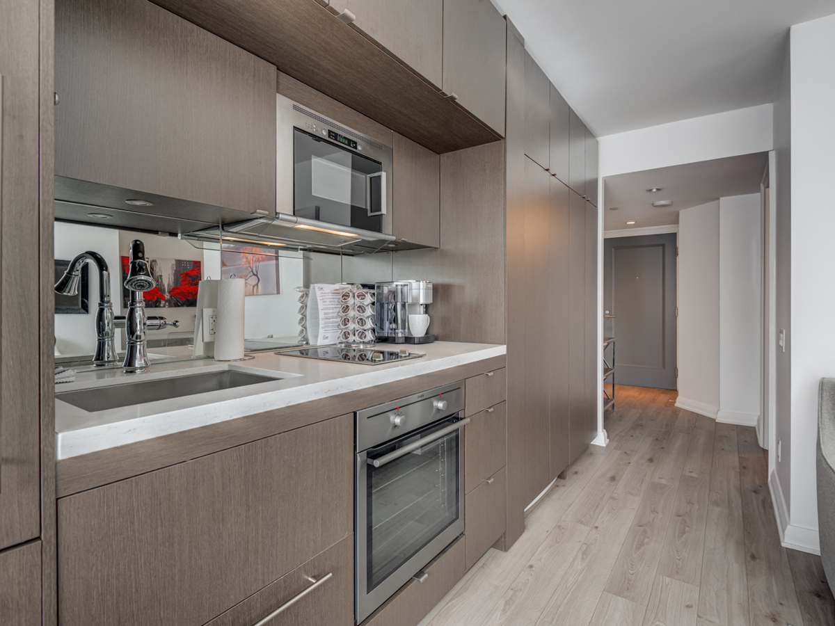 Linear kitchen with abundant storage cabinets and drawers.