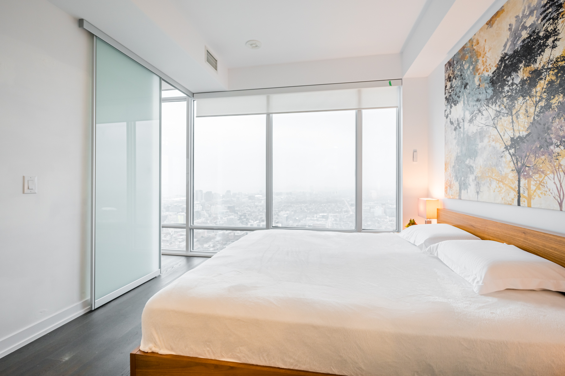 Large bedroom windows with electric blinds.