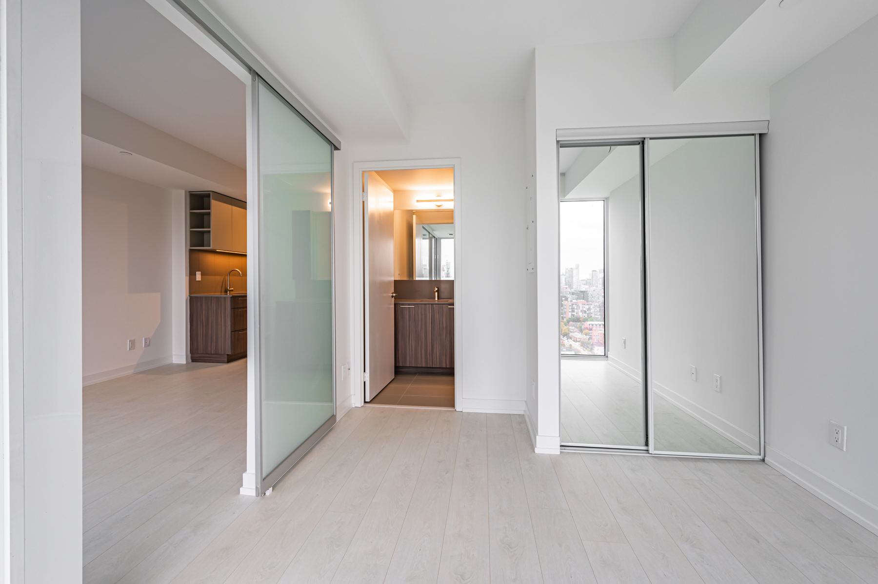 19 Western Battery Rd Suite 2921 master bedroom with closet and sliding doors.