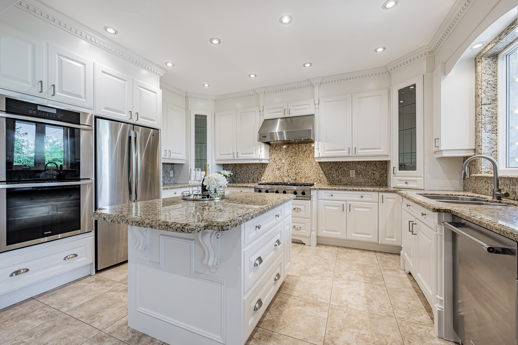 12 Highland Hill new kitchen with porcelain floors, granite counters, white cabinets.