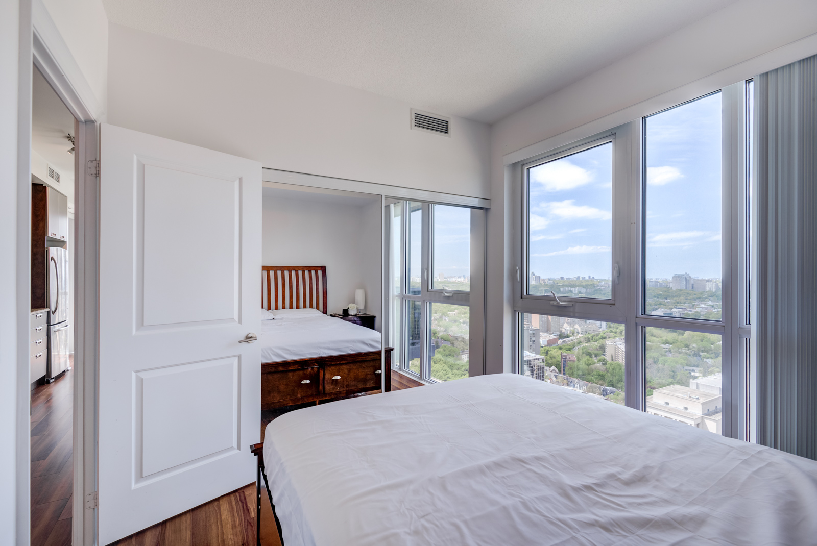 Master bedroom's closet mirror doors reflecting room and in 28 Ted Rogers Way Unit 3609.