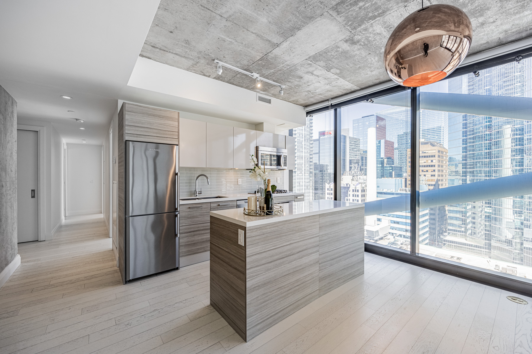 Condo kitchen island with white quartz top.