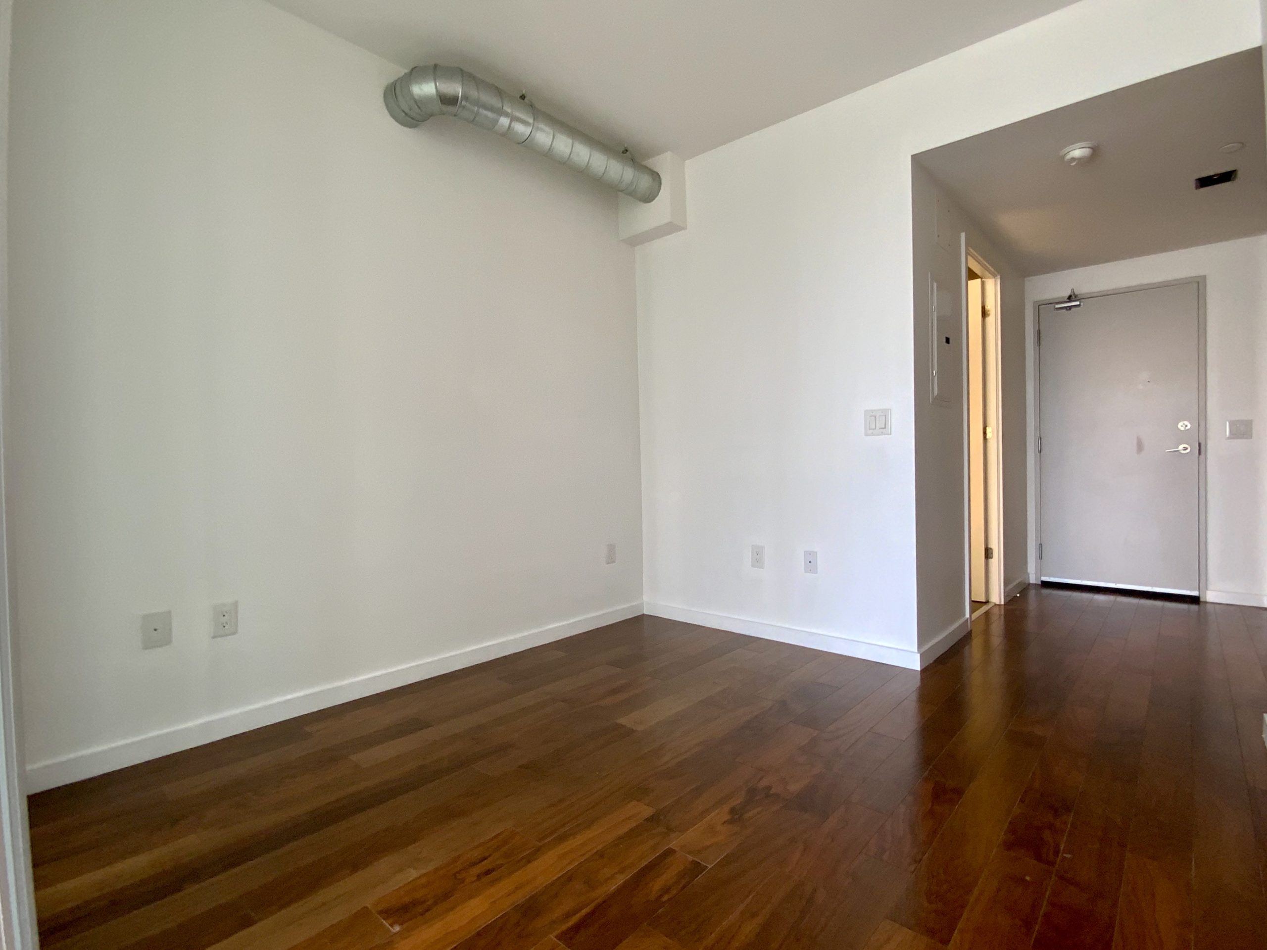 Soft loft condo bedroom with exposed ventilation.