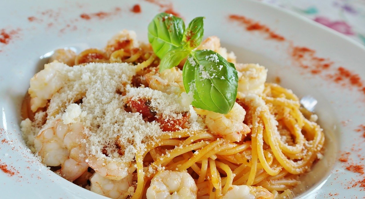 Plate of spaghetti with grated white cheese and parsley in Bathurst restaurant.