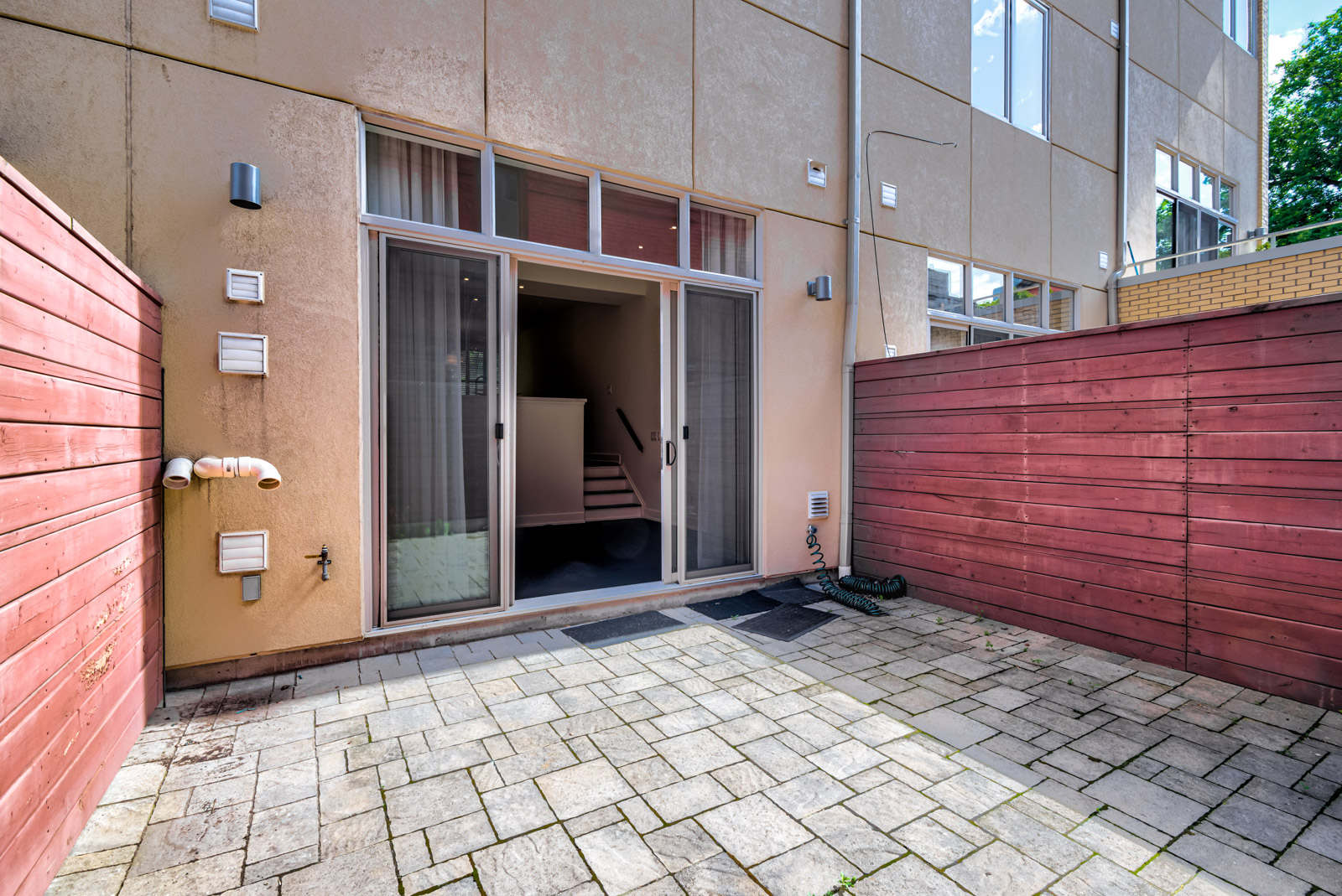 condo patio with stone floors and red wood walls