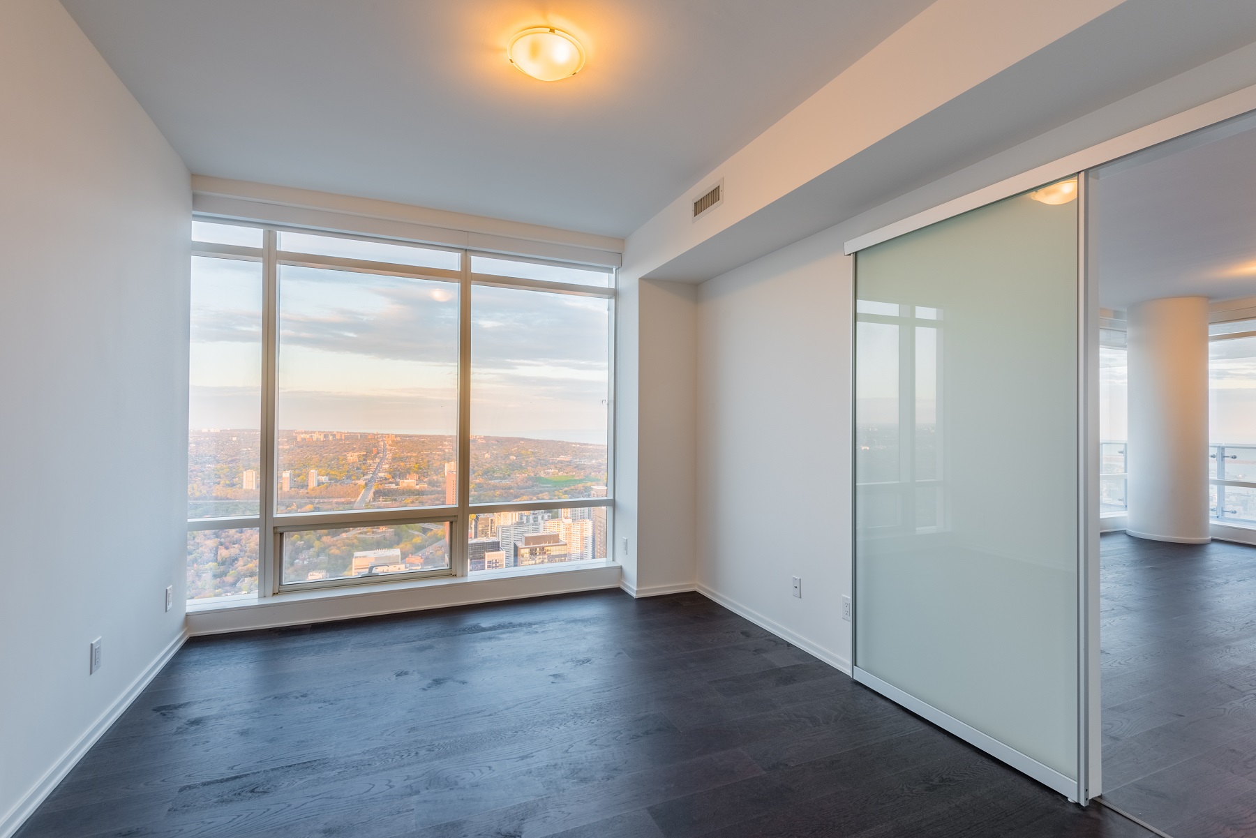 The master bedroom is tall, spacious and offers scenic views of Toronto.