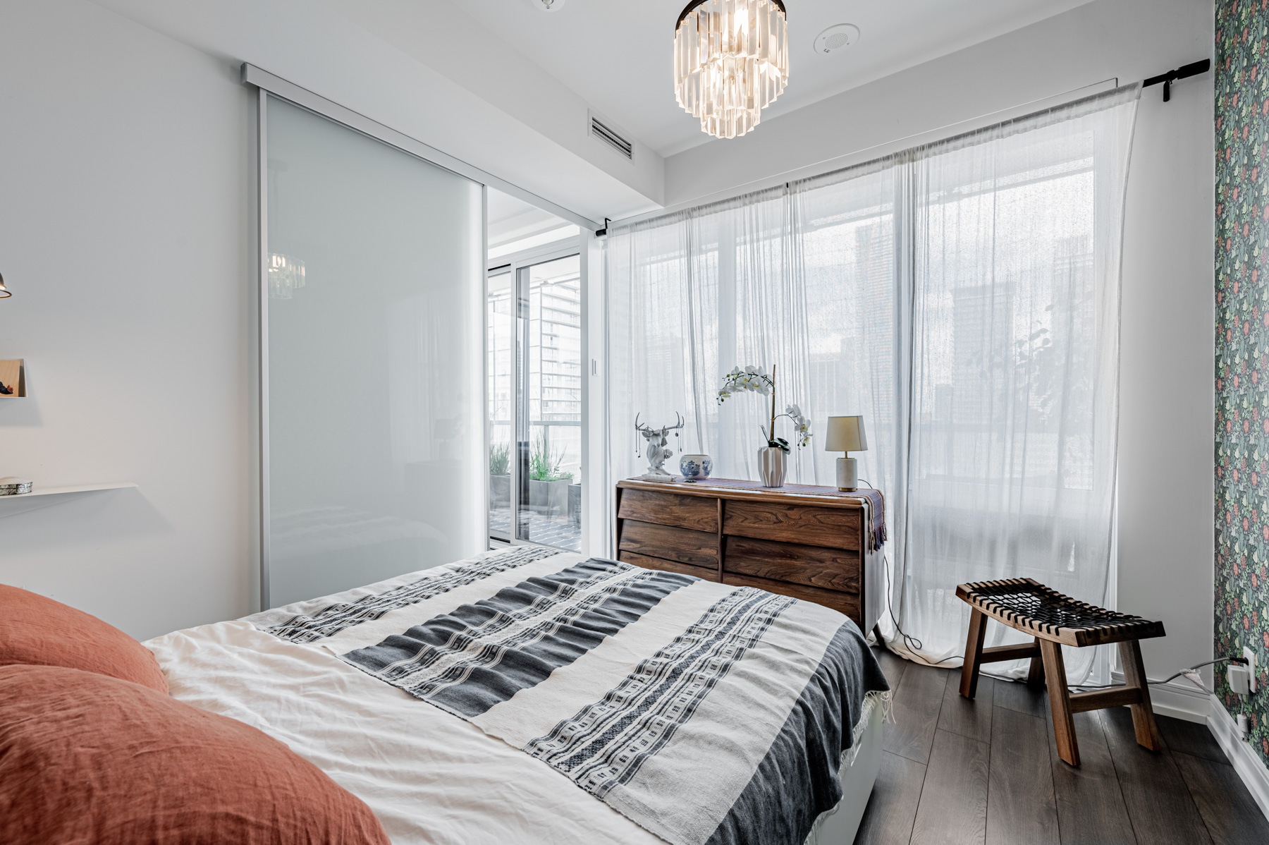 Condo bedroom overlooking balcony.