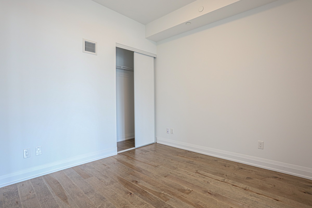 403 Church St #1101 master bedroom with matching gray closet and walls.