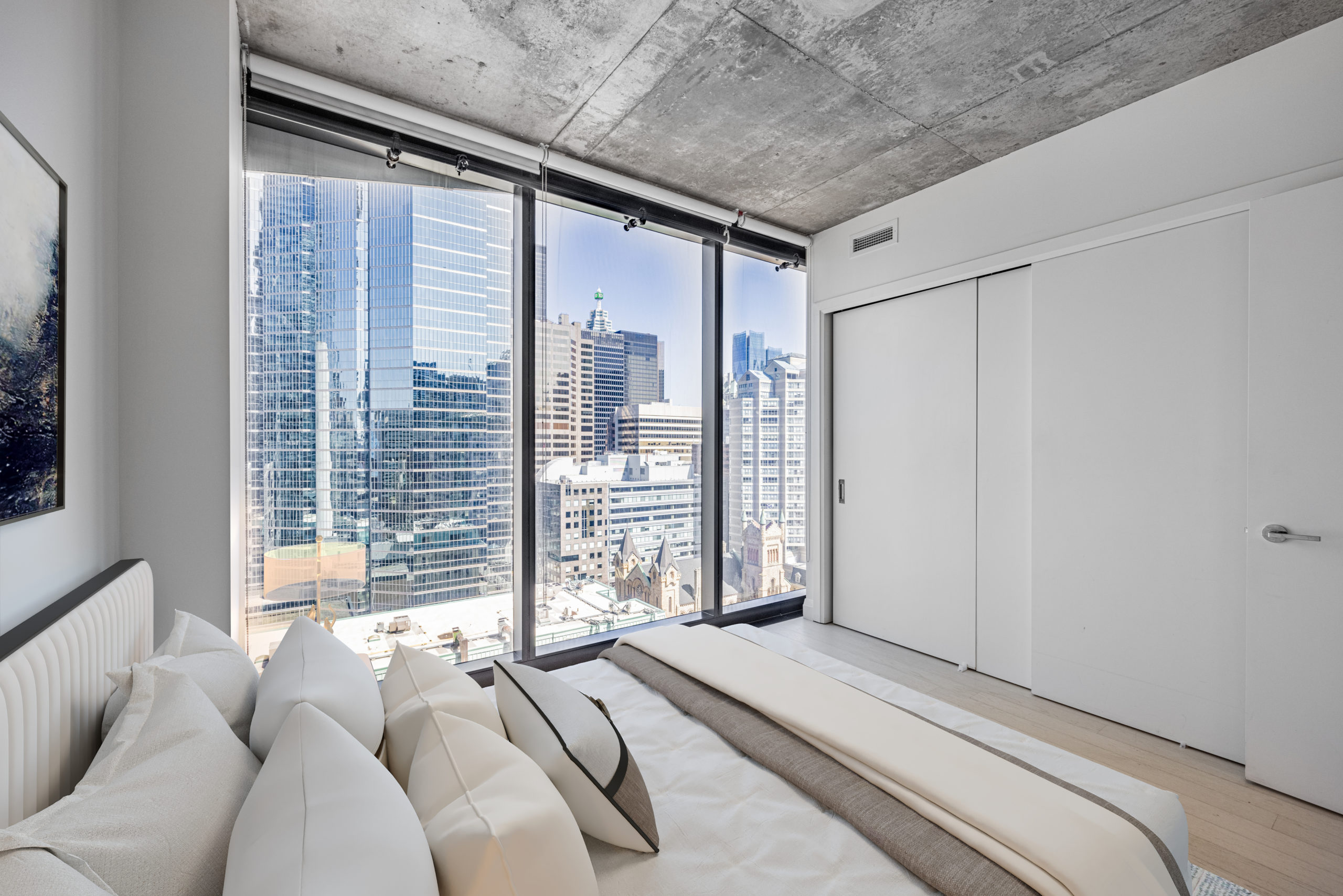Condo bedroom with floor-to-ceiling windows – 224 King St W Unit 1504.