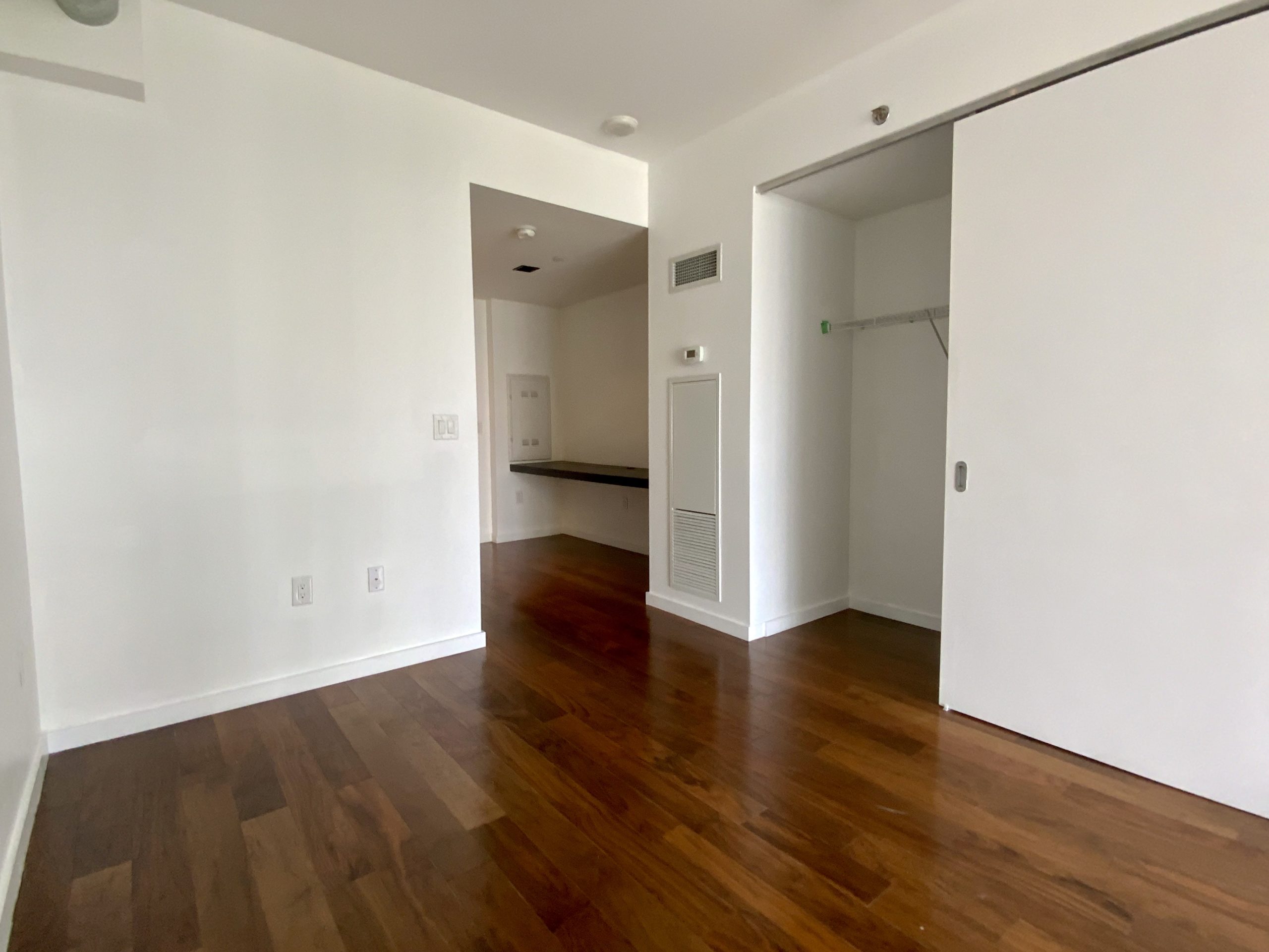 Condo bedroom with sliding door closet.