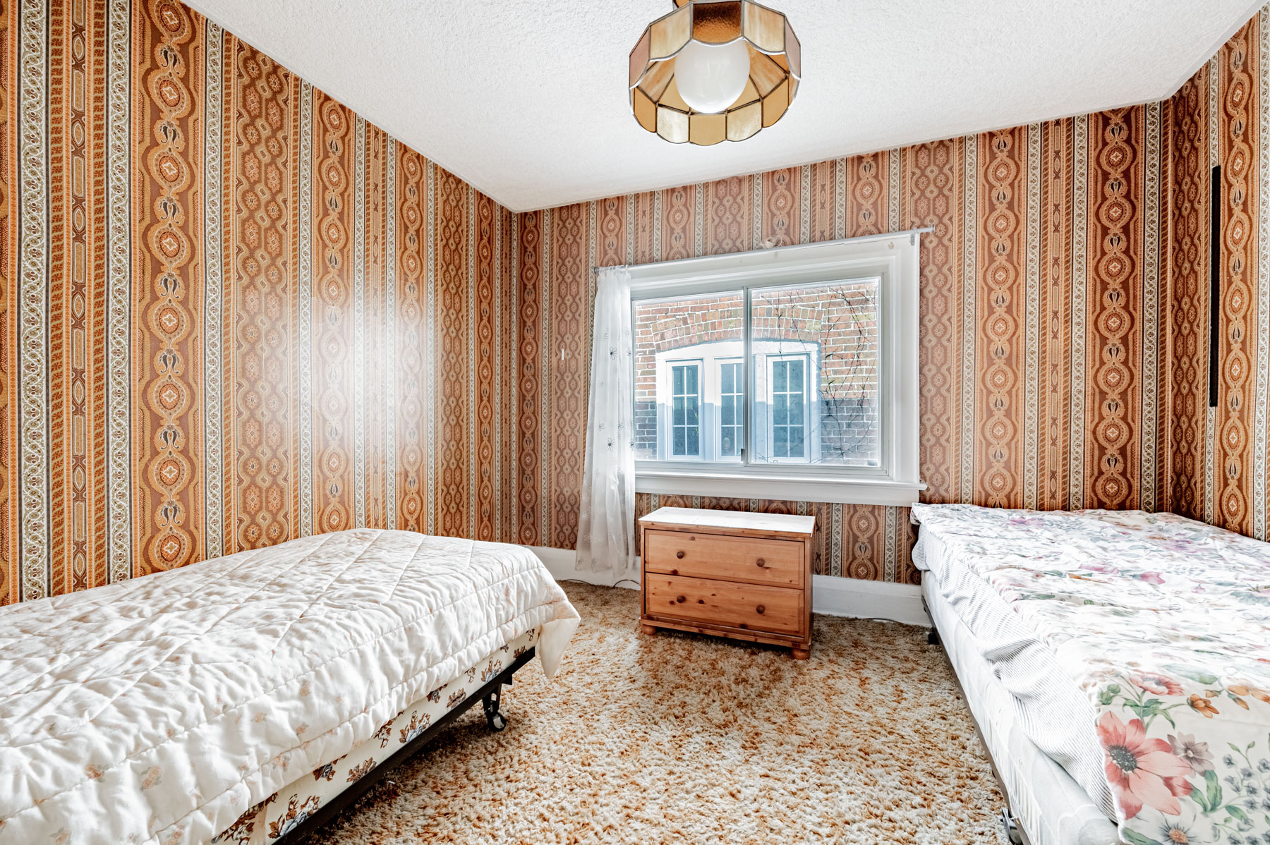 Bedroom with broadloom floors, 2 beds, ornate wallpaper and window – 35 Woburn Ave.