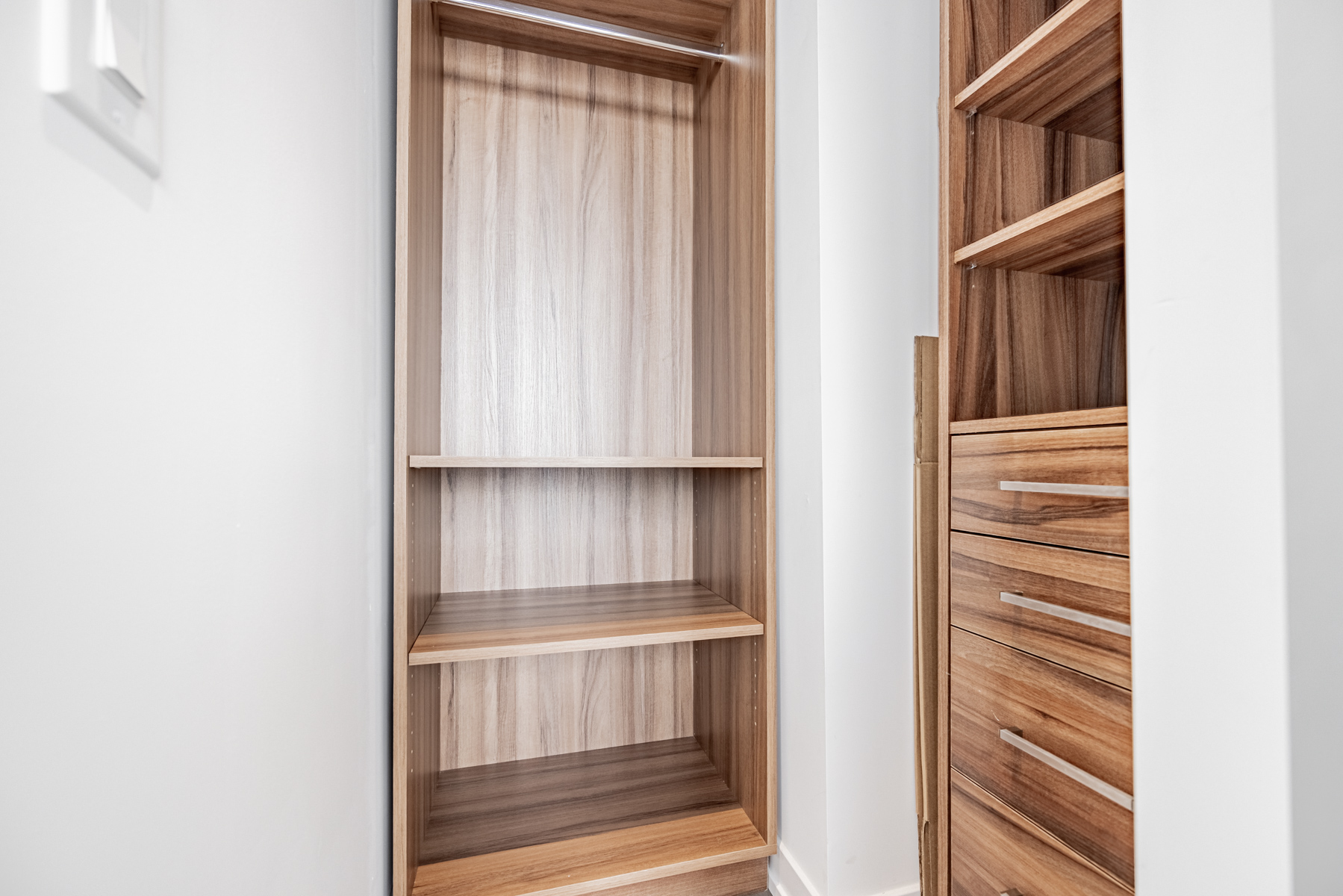 Walk-in closet with built-in shelves.