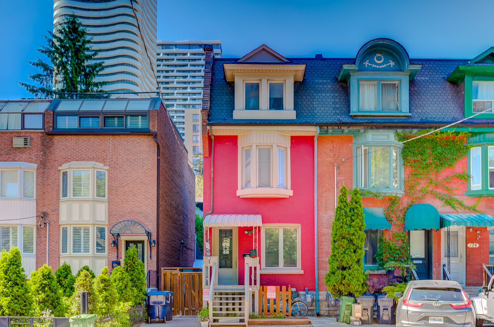 3-storey red-brick Victorian house with white Mercedes Benz in driveway of 120 McGill St, Toronto.