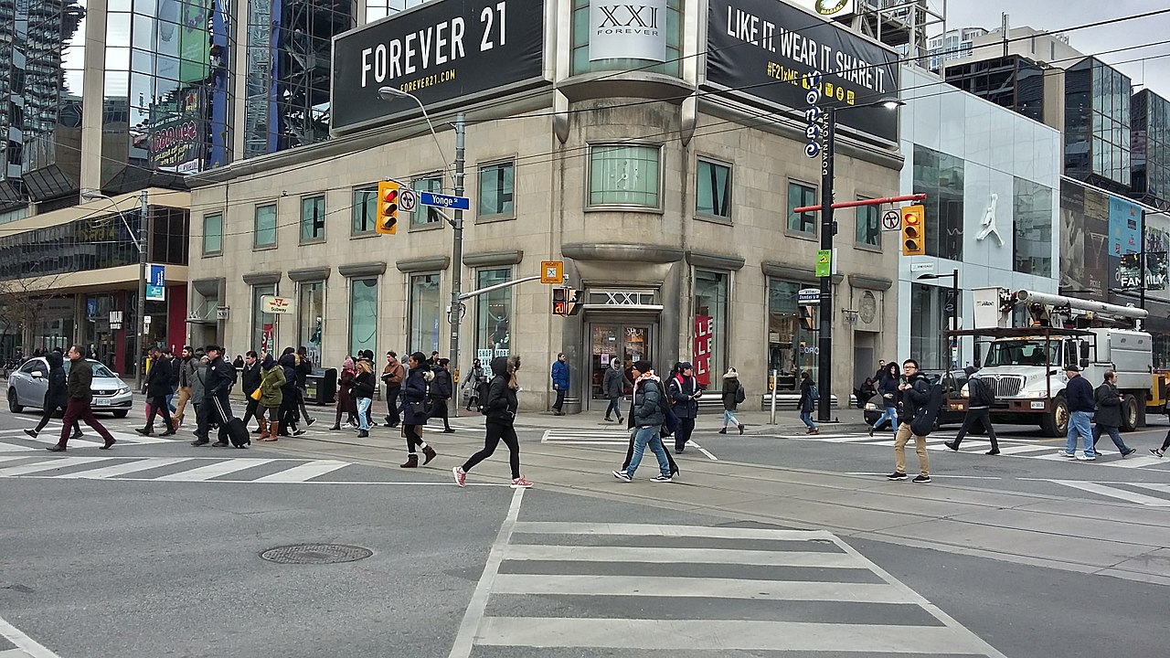 Photo of Yonge Street. So many people crossing the street.