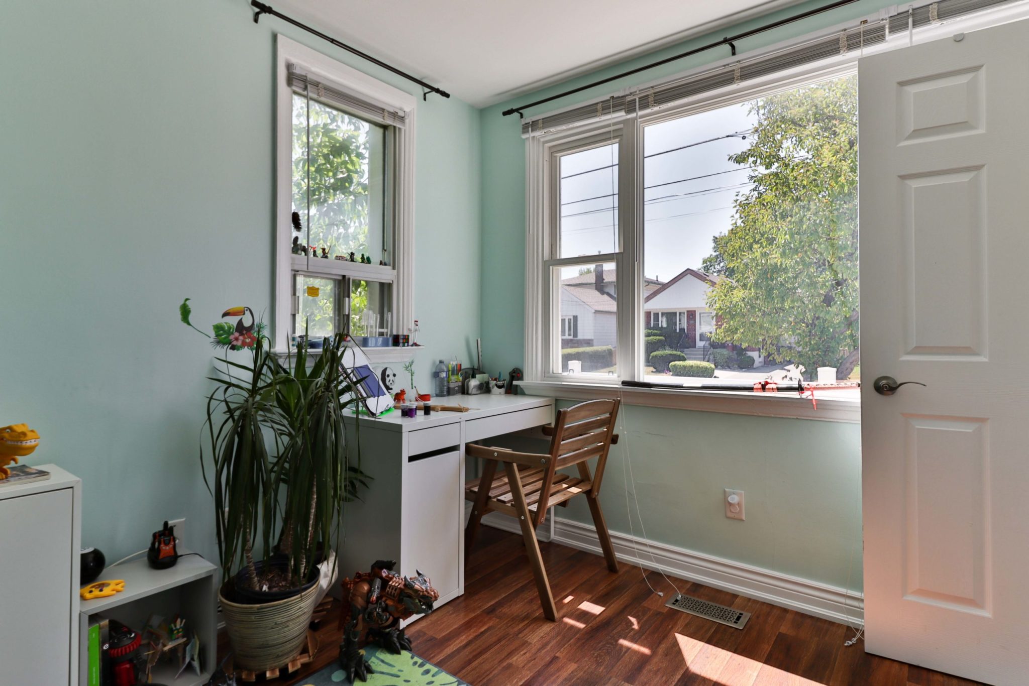 Bedroom with two windows facing street.