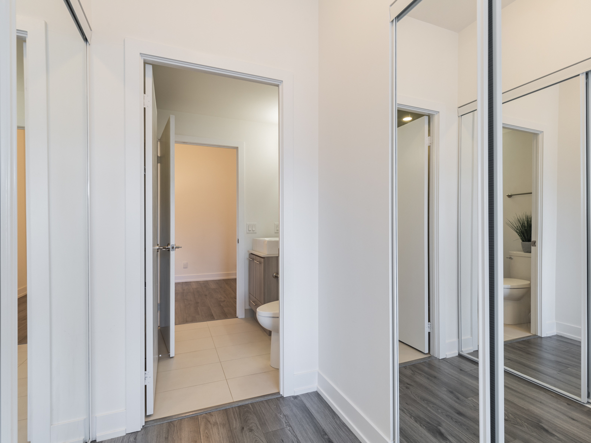 Condo with two mirror-door closets on either side.